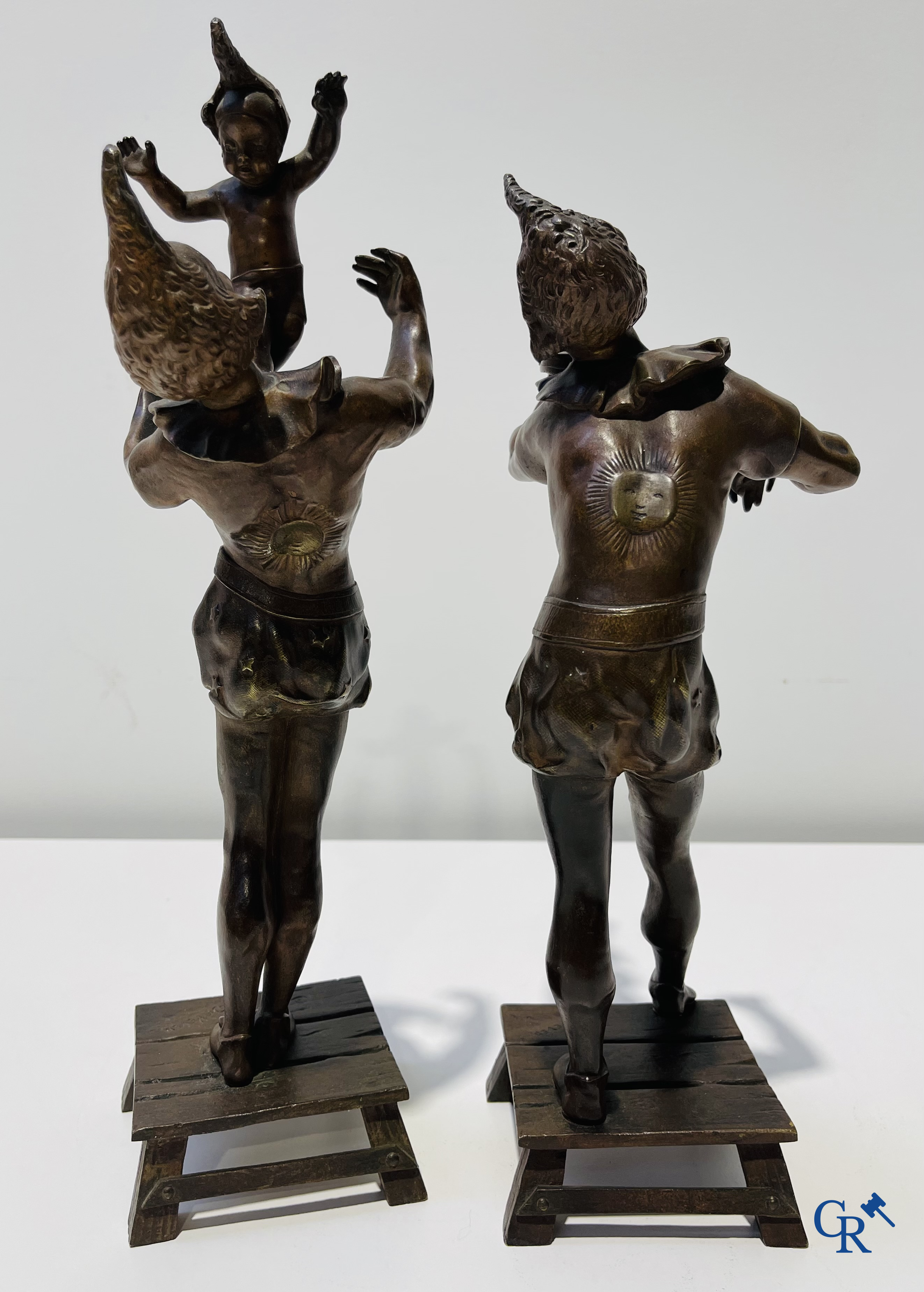 Auguste de Wever (1836-1910) Pair of bronze statues, harlequin with child and music playing harlequin.