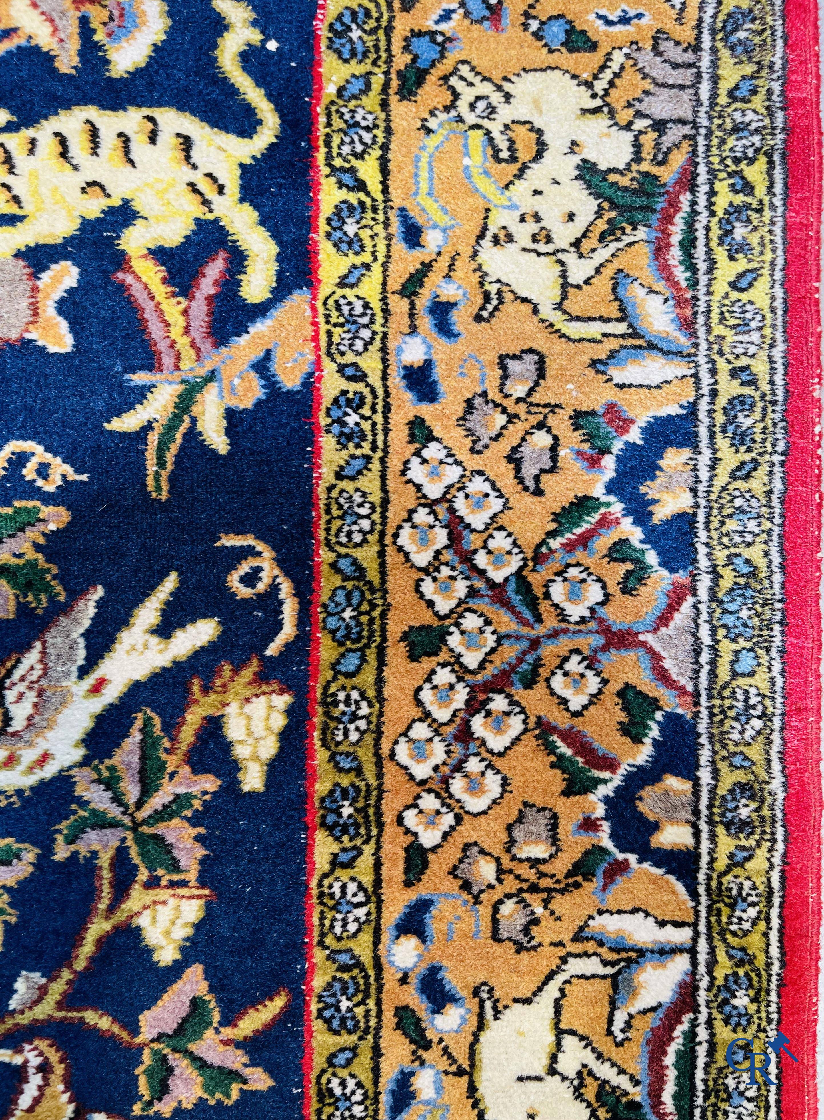 Oriental carpets: Iran, hand-knotted Persian carpet with decor of forest animals.