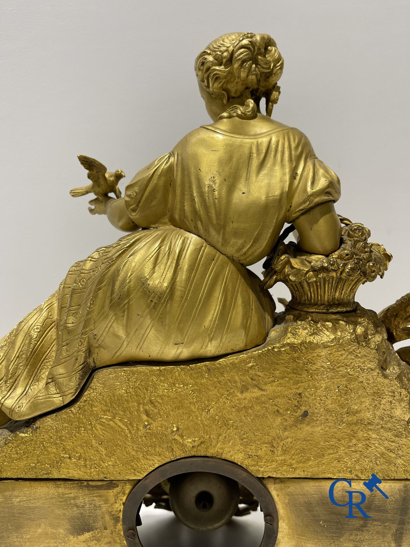 Bronze gilded clock with a romantic performance. 19th century.