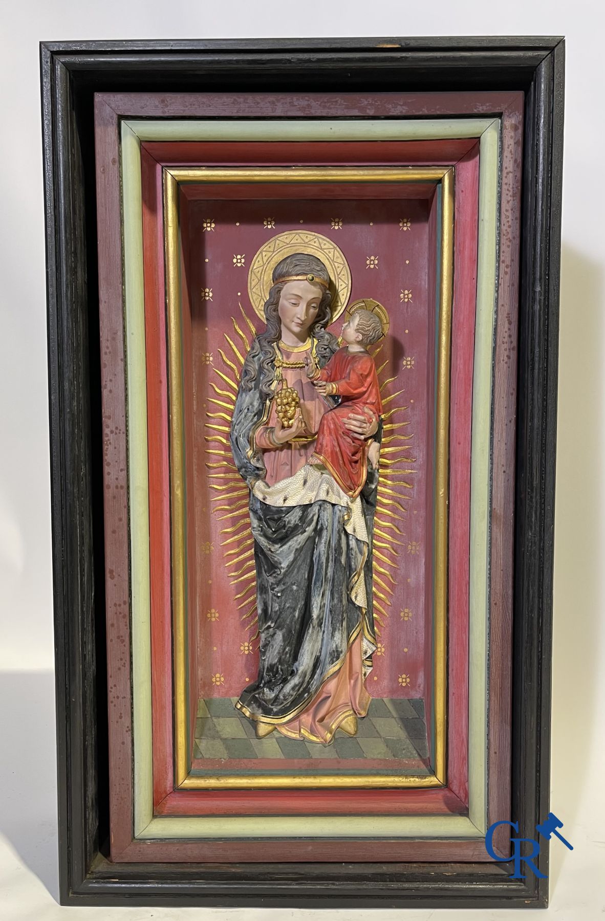 A 19th century wooden statue of Christ and a wooden display case with plaster representation of Mary with child.