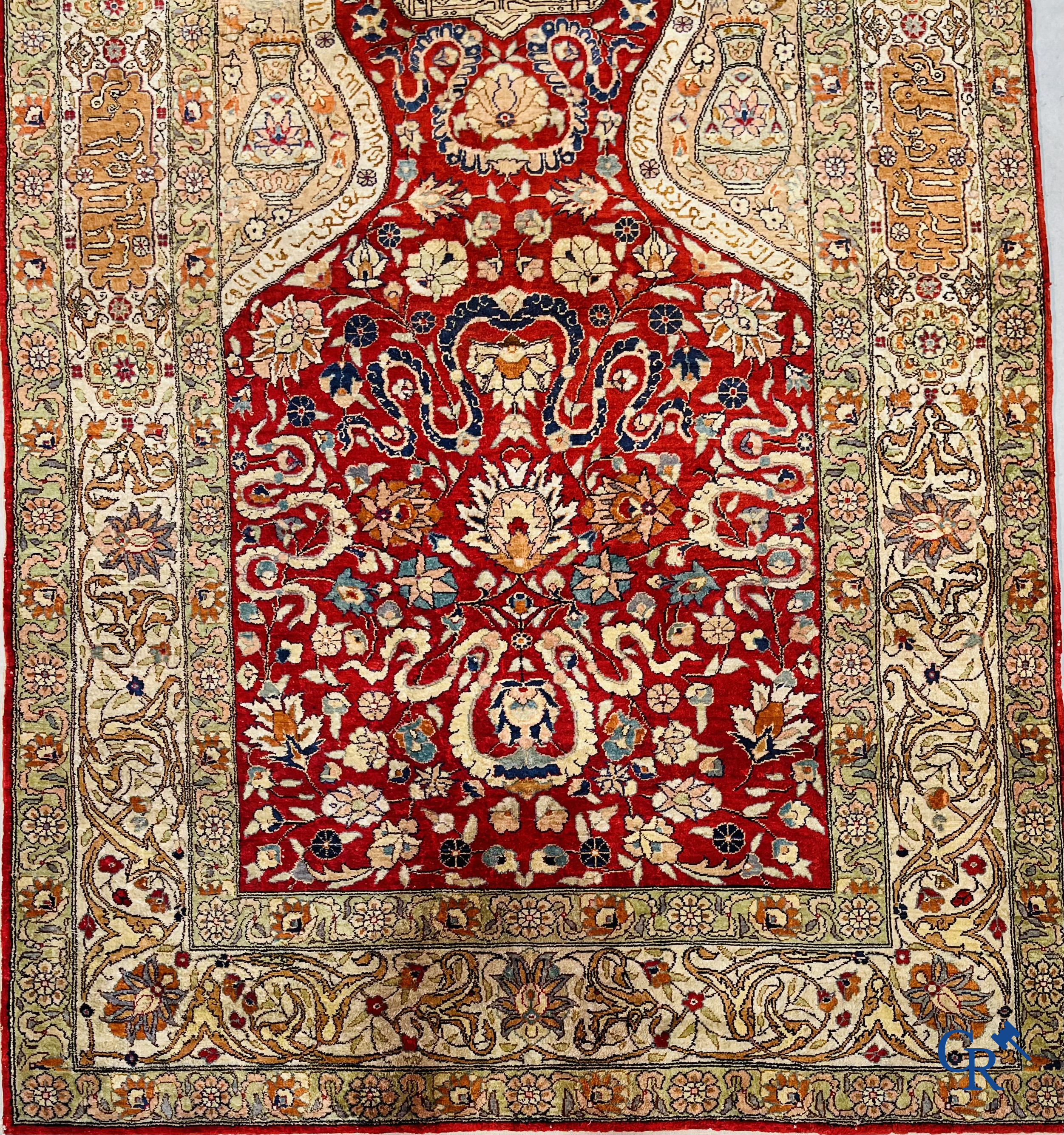 Oriental carpets: Hereke, a finely knotted silk carpet with inscriptions and birds in a floral decor.