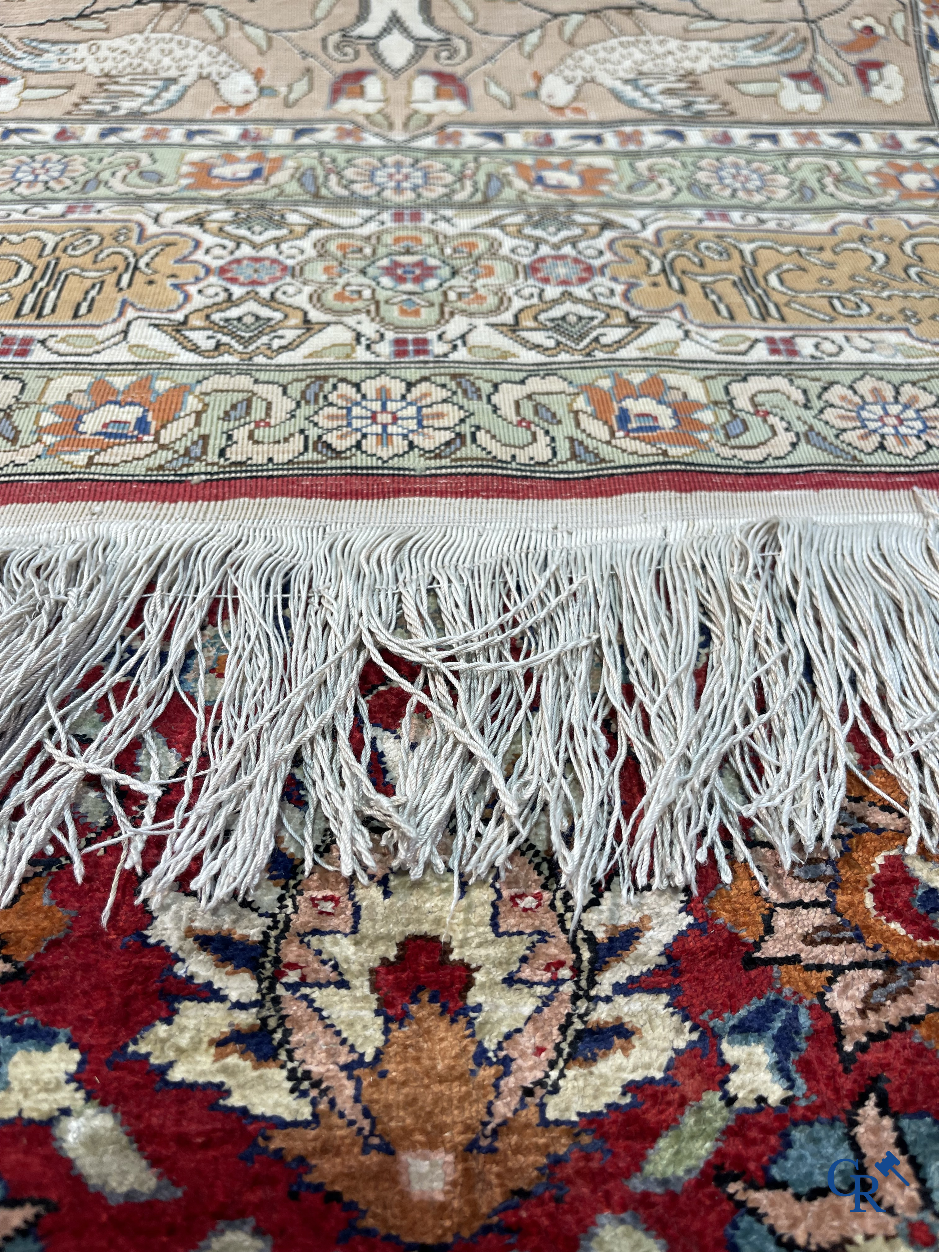 Oriental carpets: Hereke, a finely knotted silk carpet with inscriptions and birds in a floral decor.