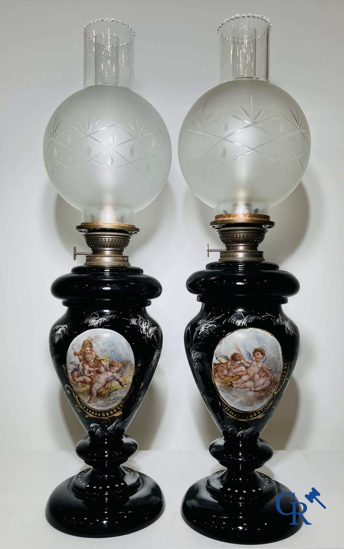 Pair of oil lamps in black opaline with enamelled decor.