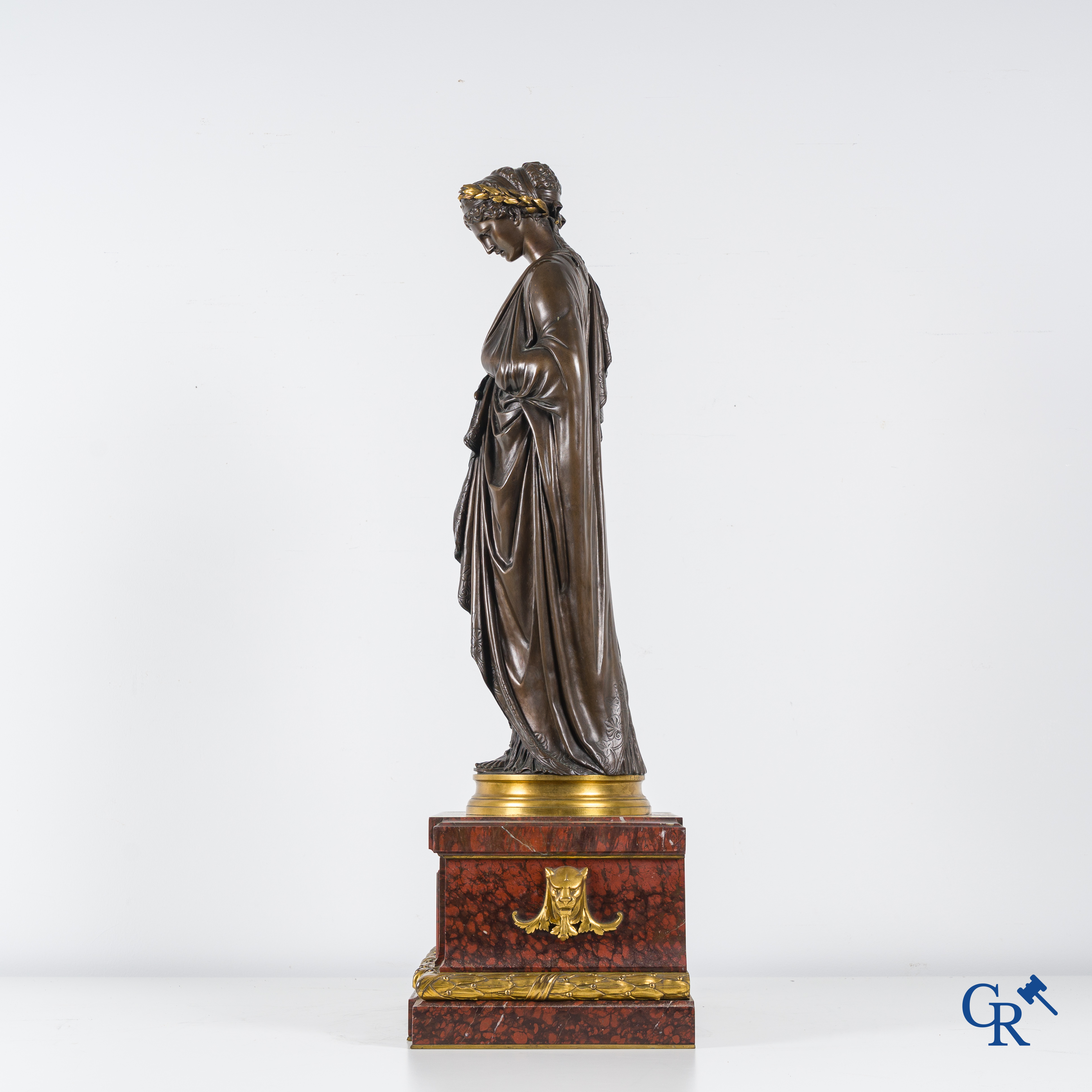 F. Barbedienne Fondeur, a bronze statue in the antique style with brown patina and gilding on a marble pedestal.