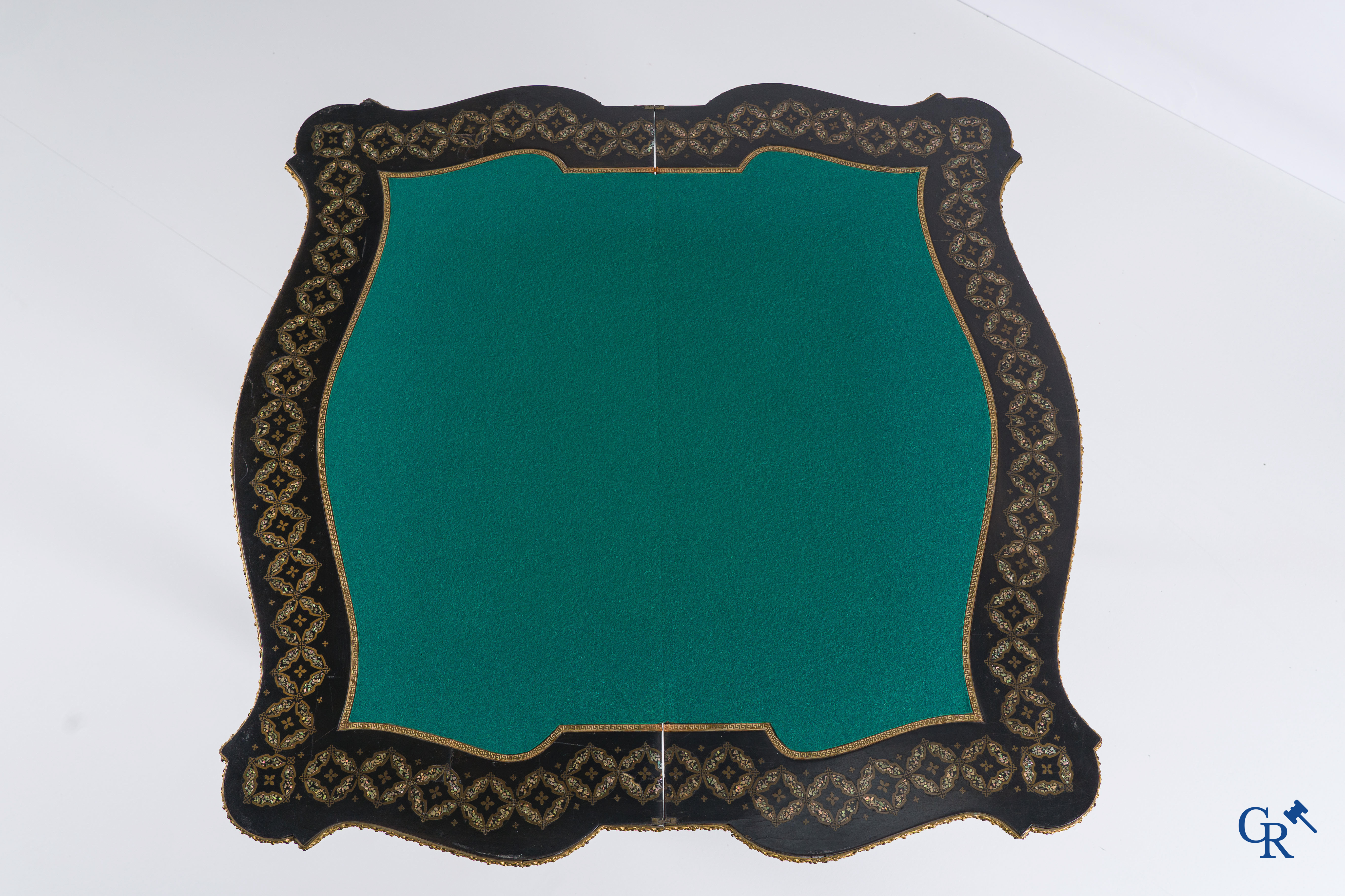 A card table with finely gilded bronze ornaments and inlay of copper and mother-of-pearl, circa 1880.