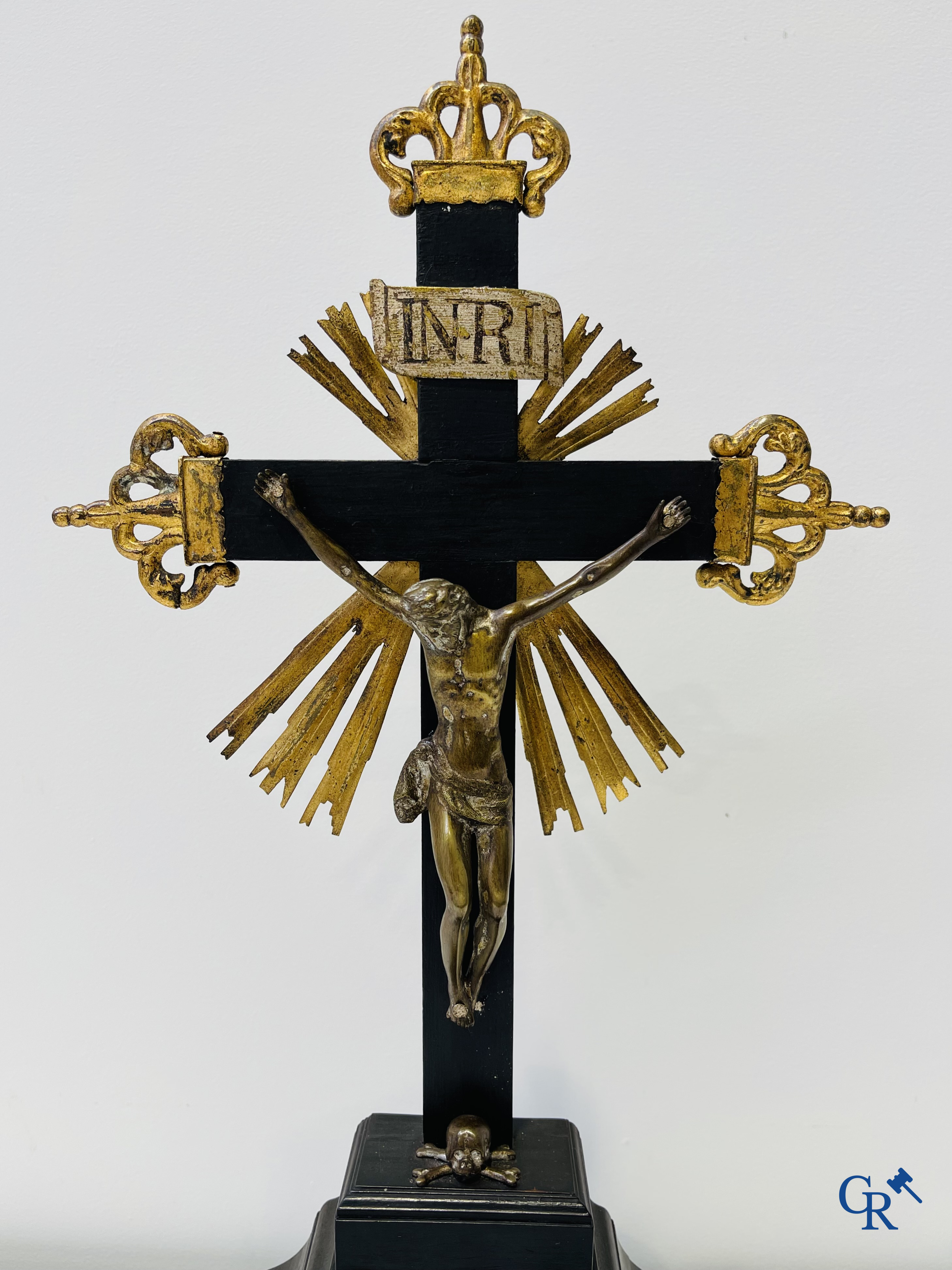 Religious objects: Bronze Christ on the cross held up by an ebony reliquary with relic.