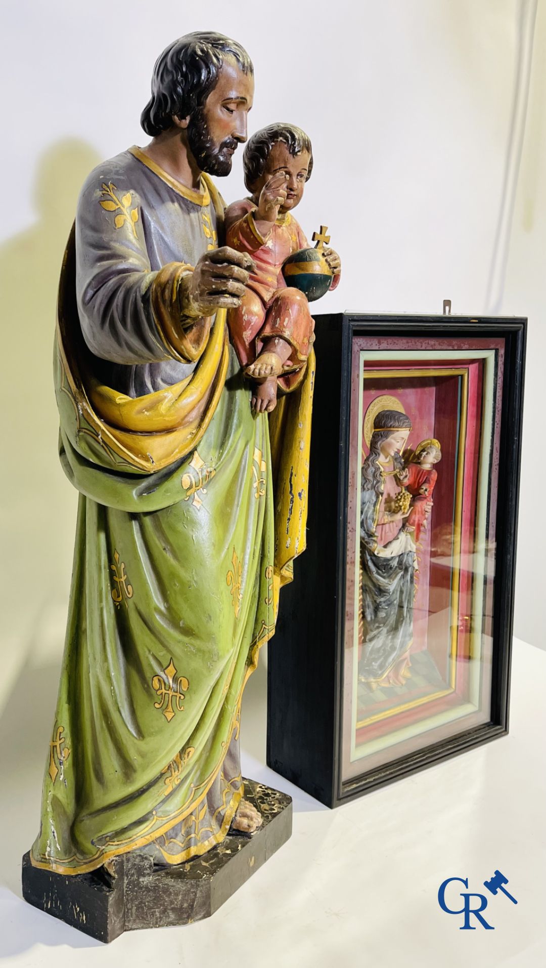 A 19th century wooden statue of Christ and a wooden display case with plaster representation of Mary with child.