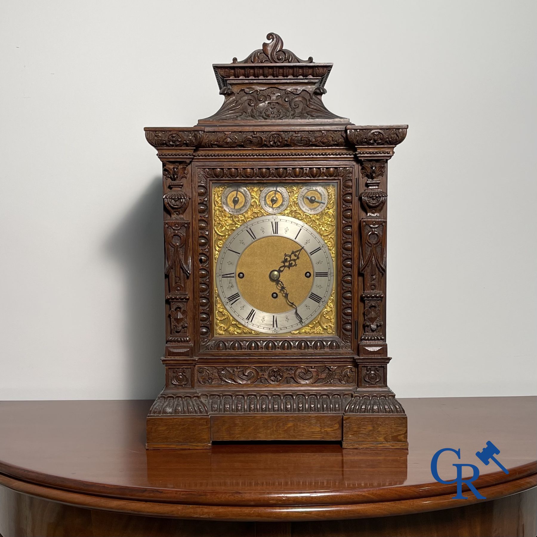 Clock with multiple bells and music in oak sculpted case with matching pedestal.