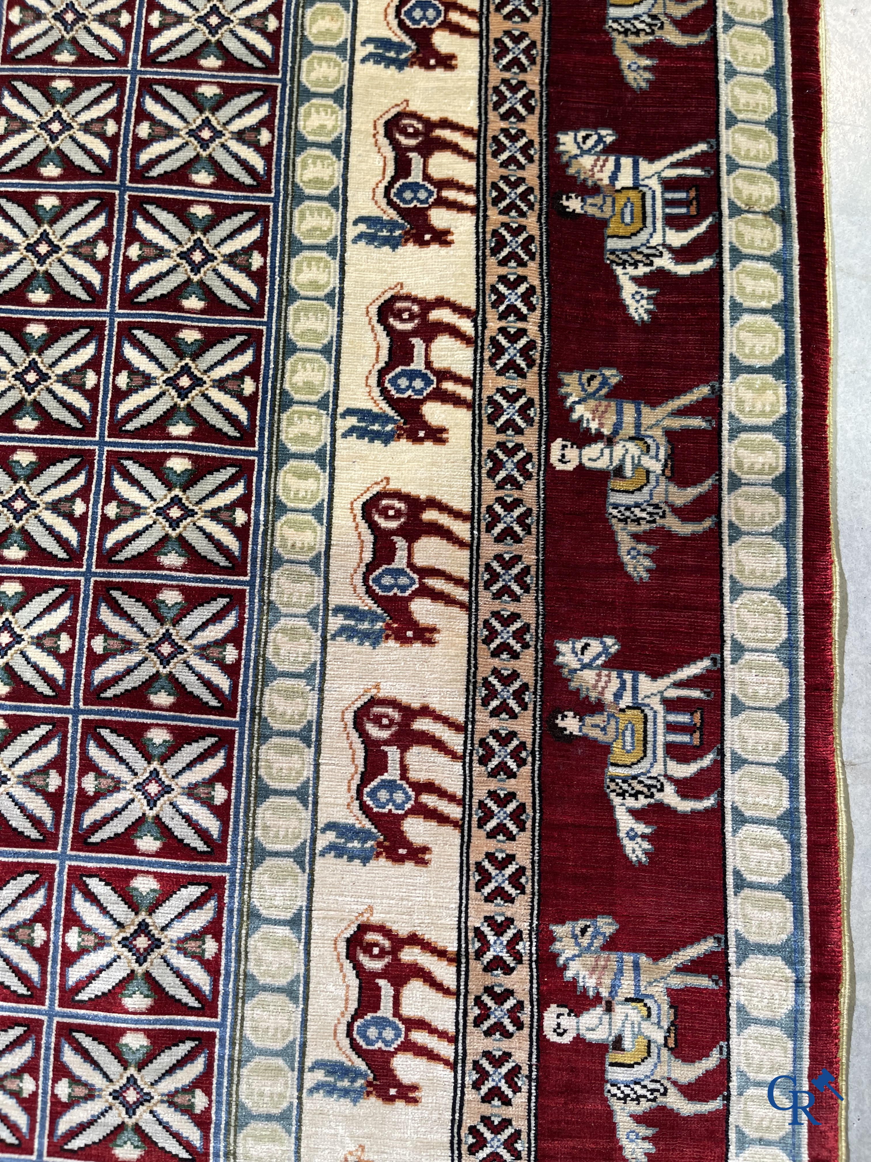 Oriental rugs: A small finely hand-knotted silk rug with deer and horsemen. Signed.