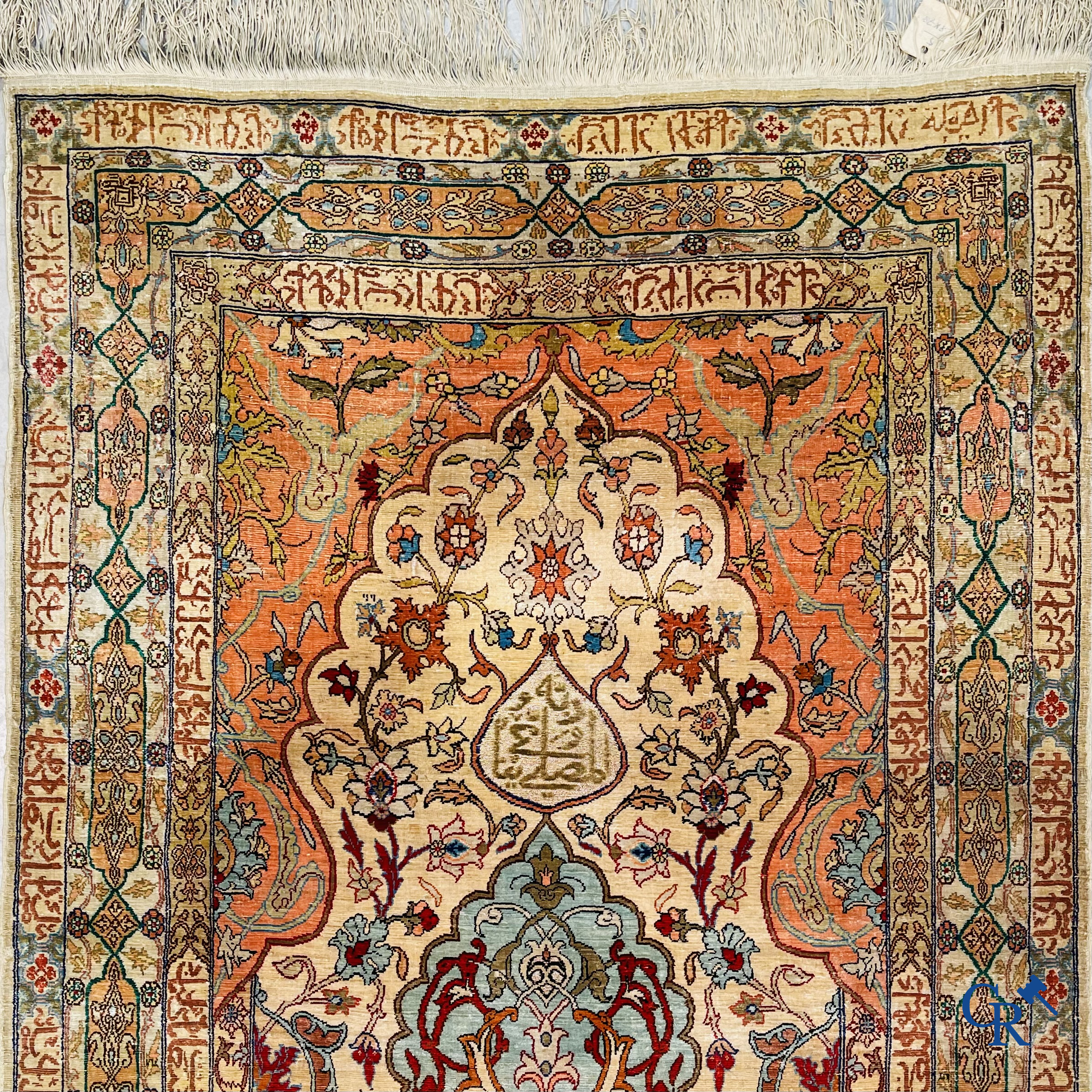 Oriental carpets, Hereke Turkey, a finely hand-knotted silk carpet with inscriptions and gold thread.