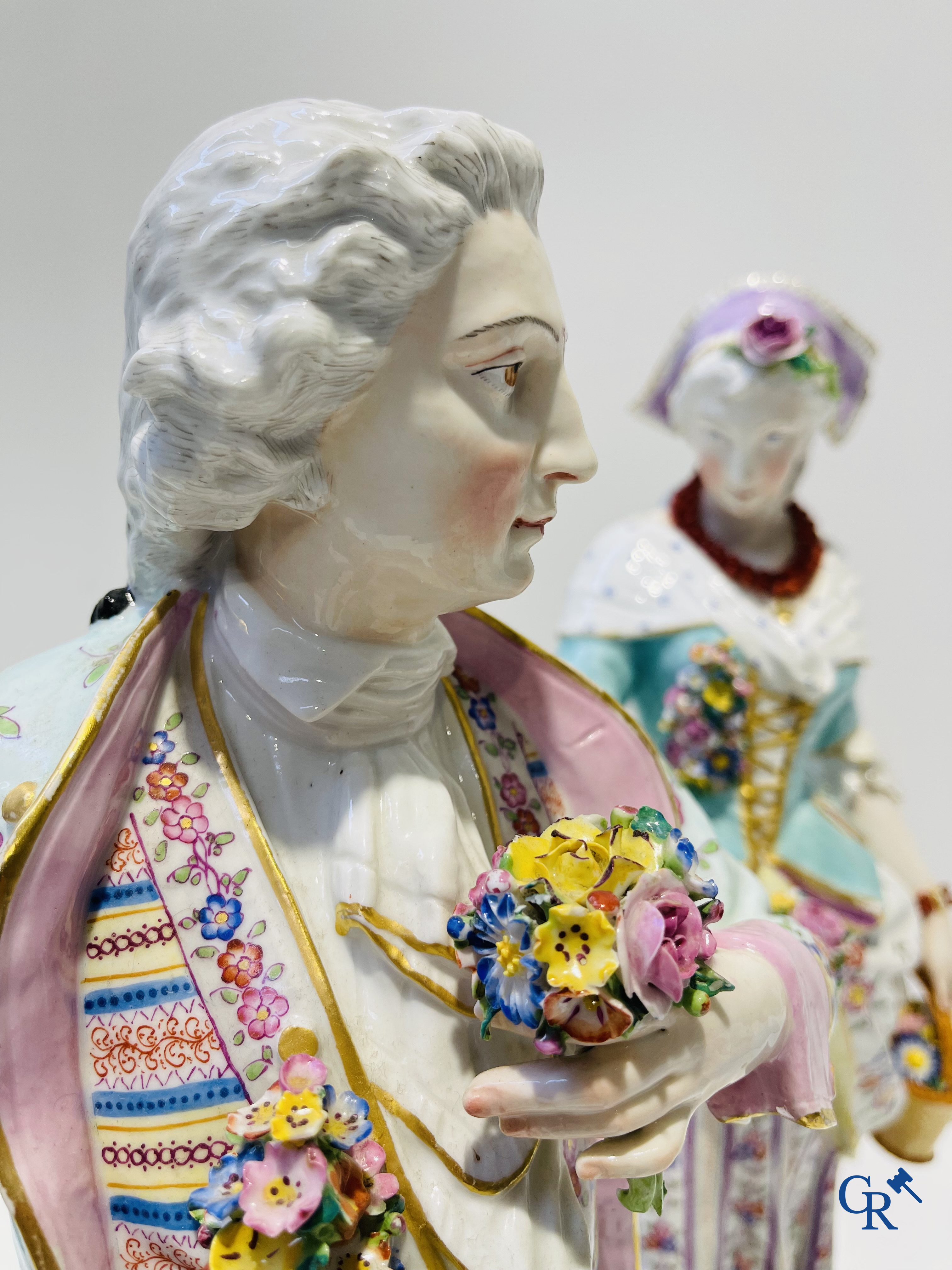 Exceptionally large pair of romantic statues in coloured and gilded porcelain in the manner of Meissen.