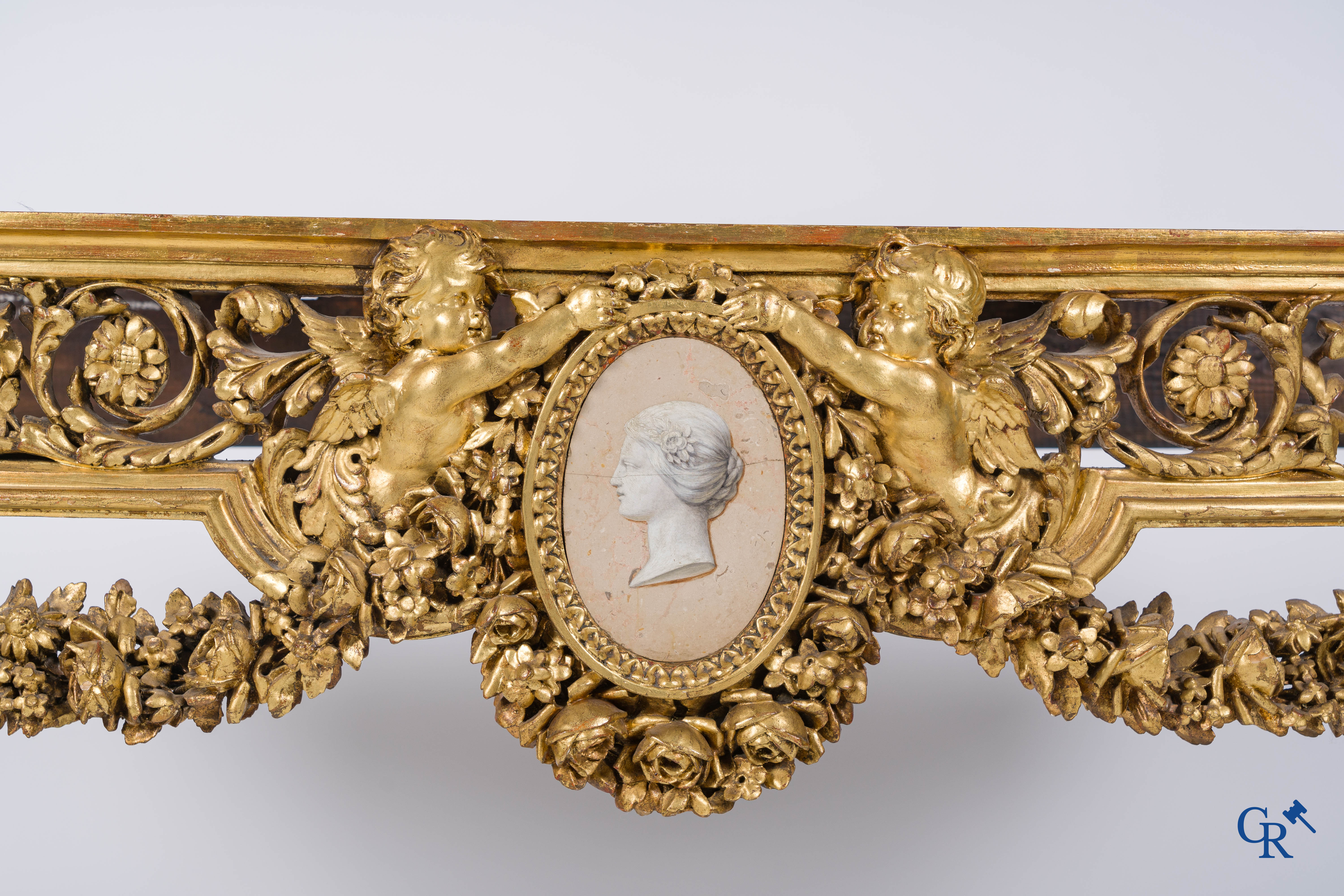 A richly carved and gilded console table in LVXI style with a grisaille painting on marble.