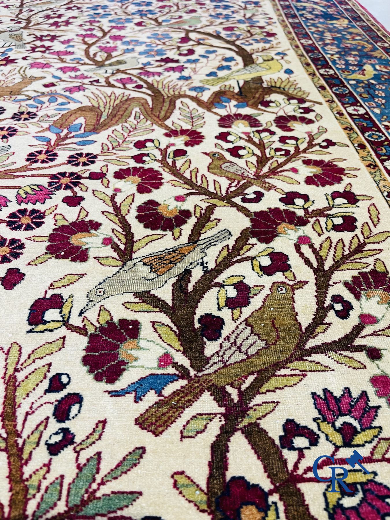 Oriental carpets: Antique oriental carpet with a decor of animals and birds in the forest.