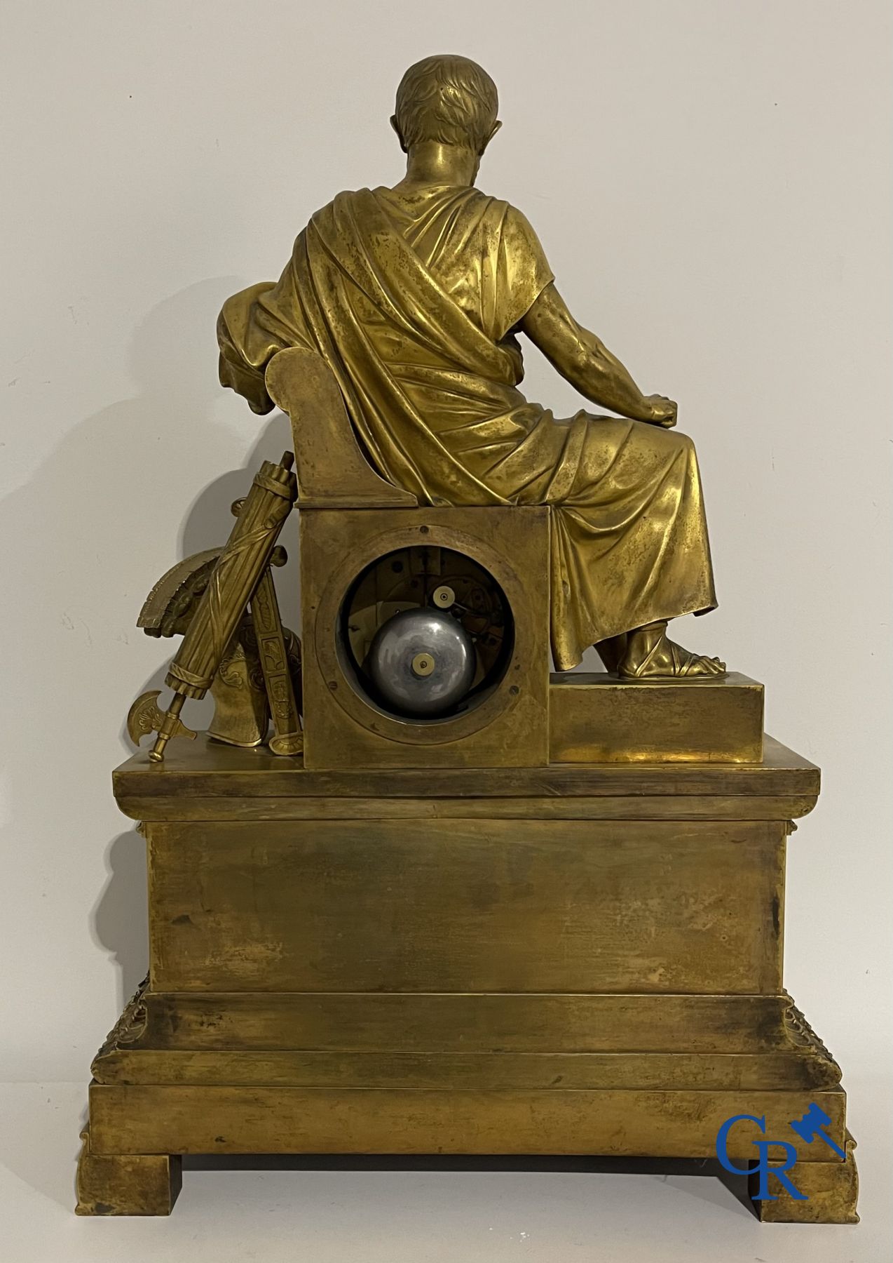 Imposing fire-gilded empire pendulum depicting a seated Roman emperor.