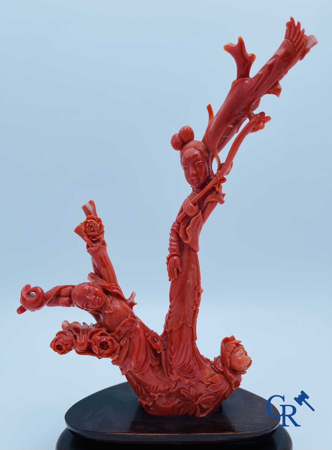 Asian Art: A Chinese group in red coral with ladies at a blossom branch. 19th century.