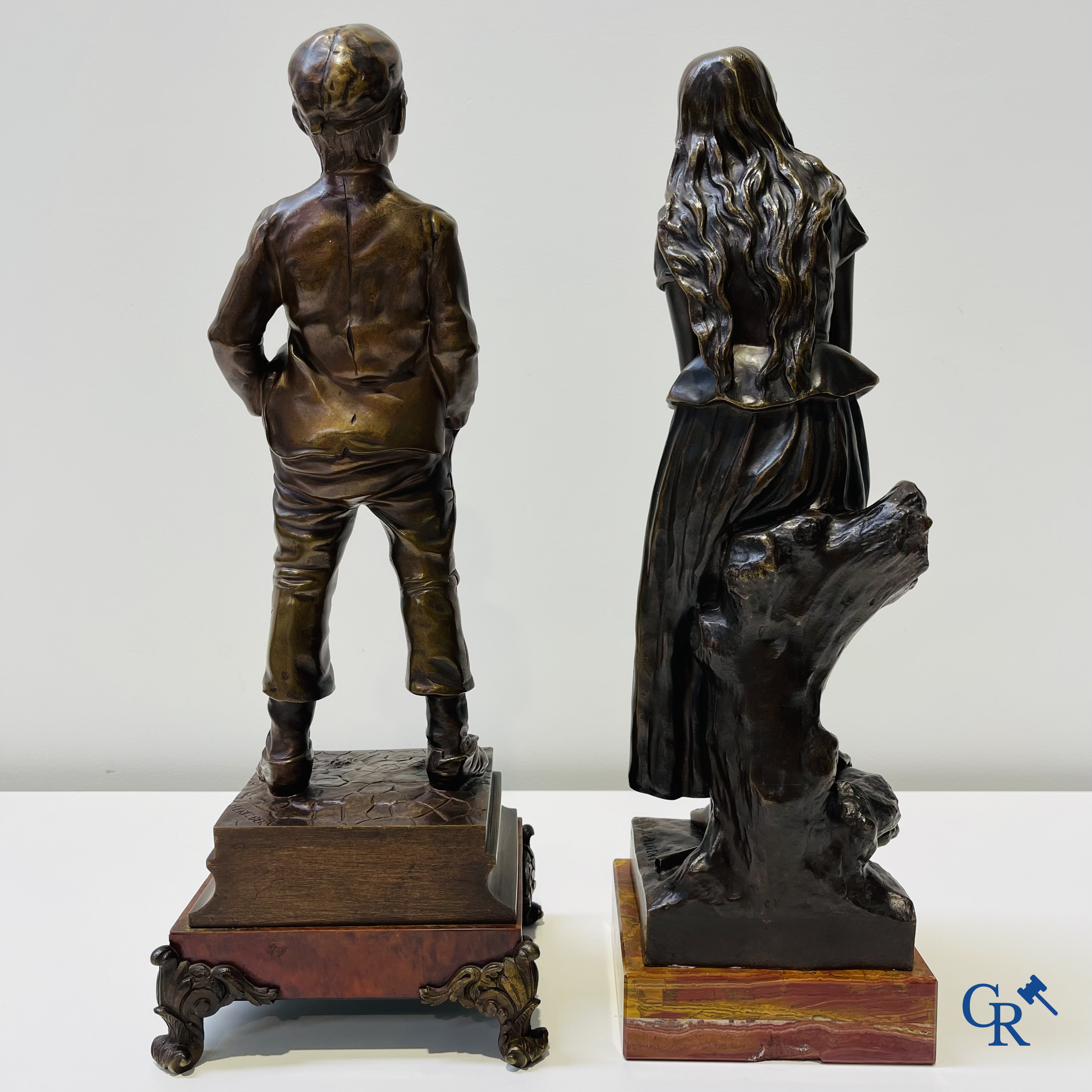 Eugène Laurent (1832-1898), dame assise et Halfdan Hertzberg (1857-1890) "le siffleur". 2 statues en bronze, signées.