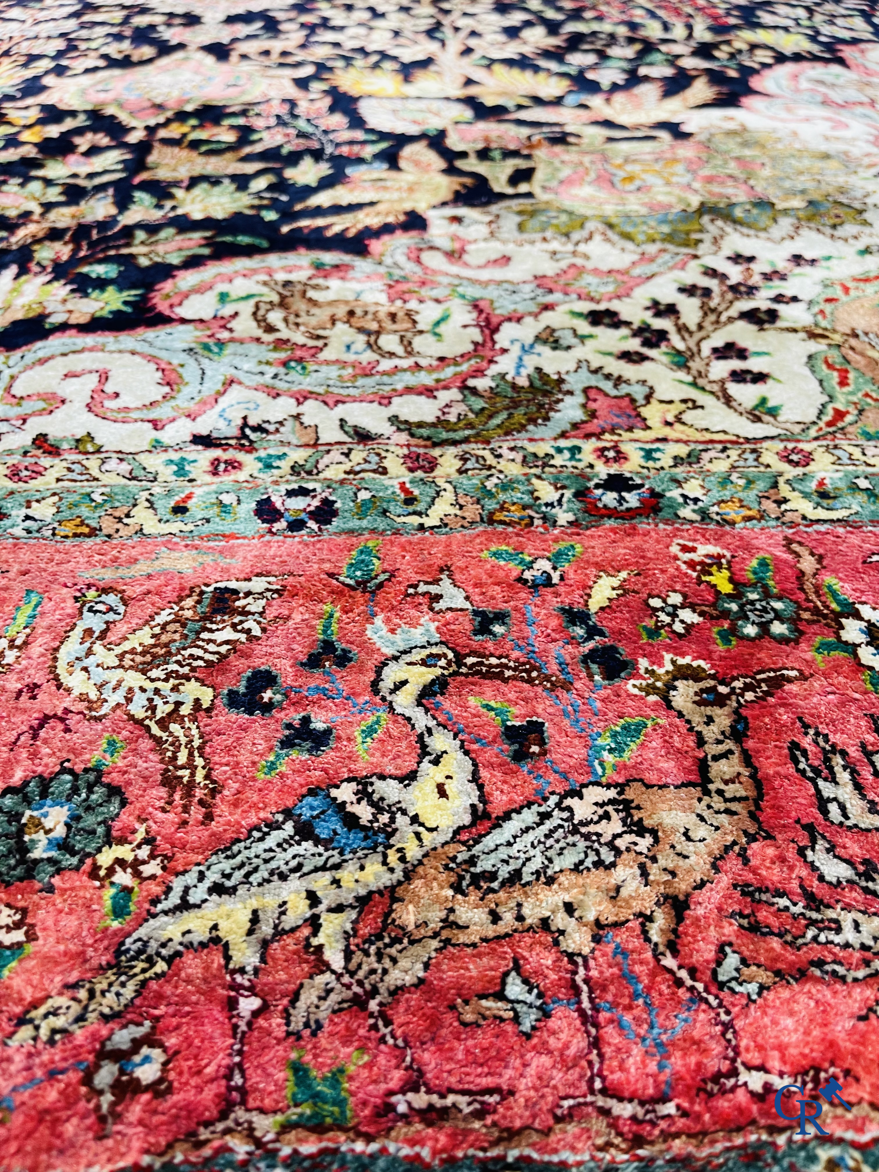 Oriental carpets: Tabriz, a finely hand-knotted silk carpet with forest animals and birds in a floral decor.