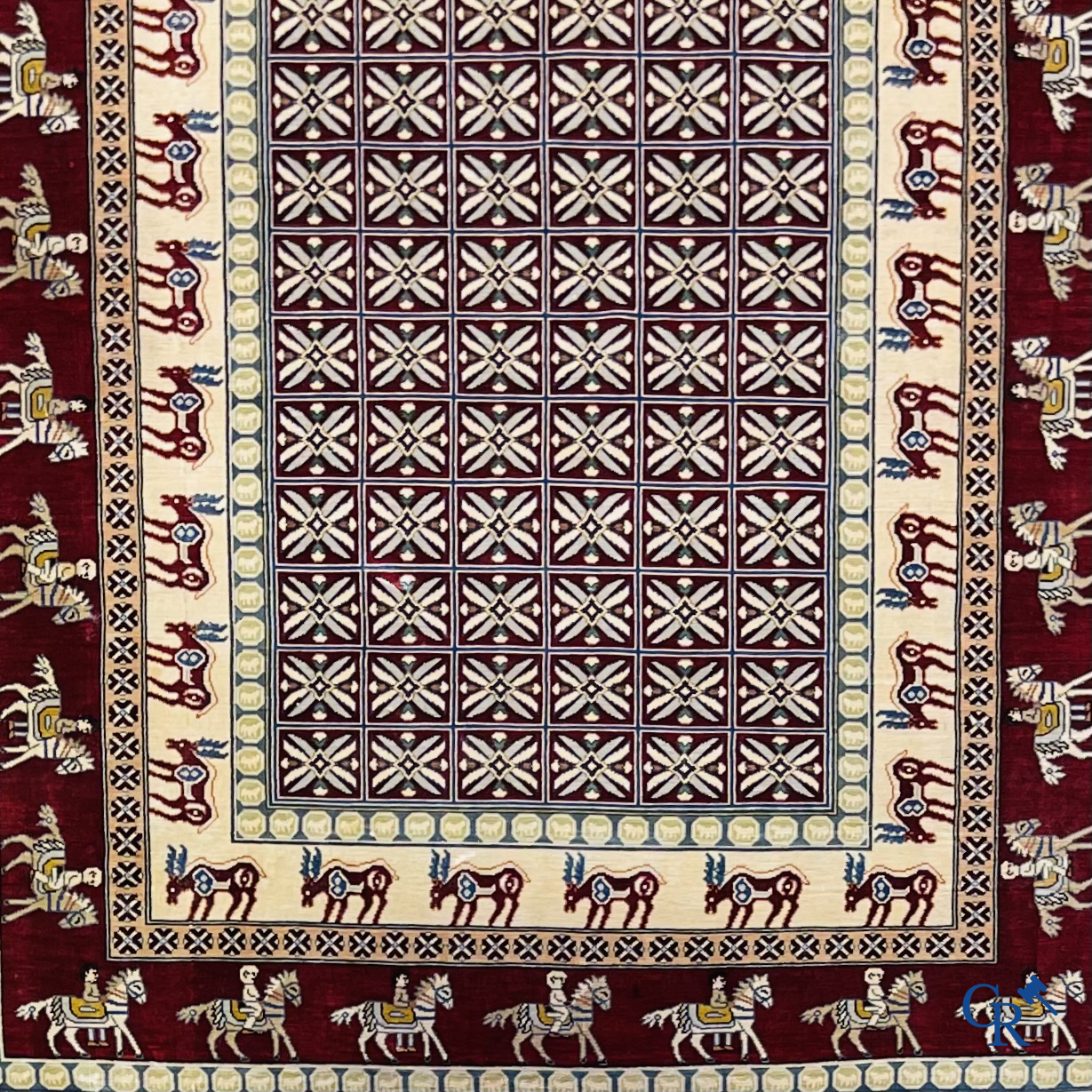 Oriental rugs: A small finely hand-knotted silk rug with deer and horsemen. Signed.