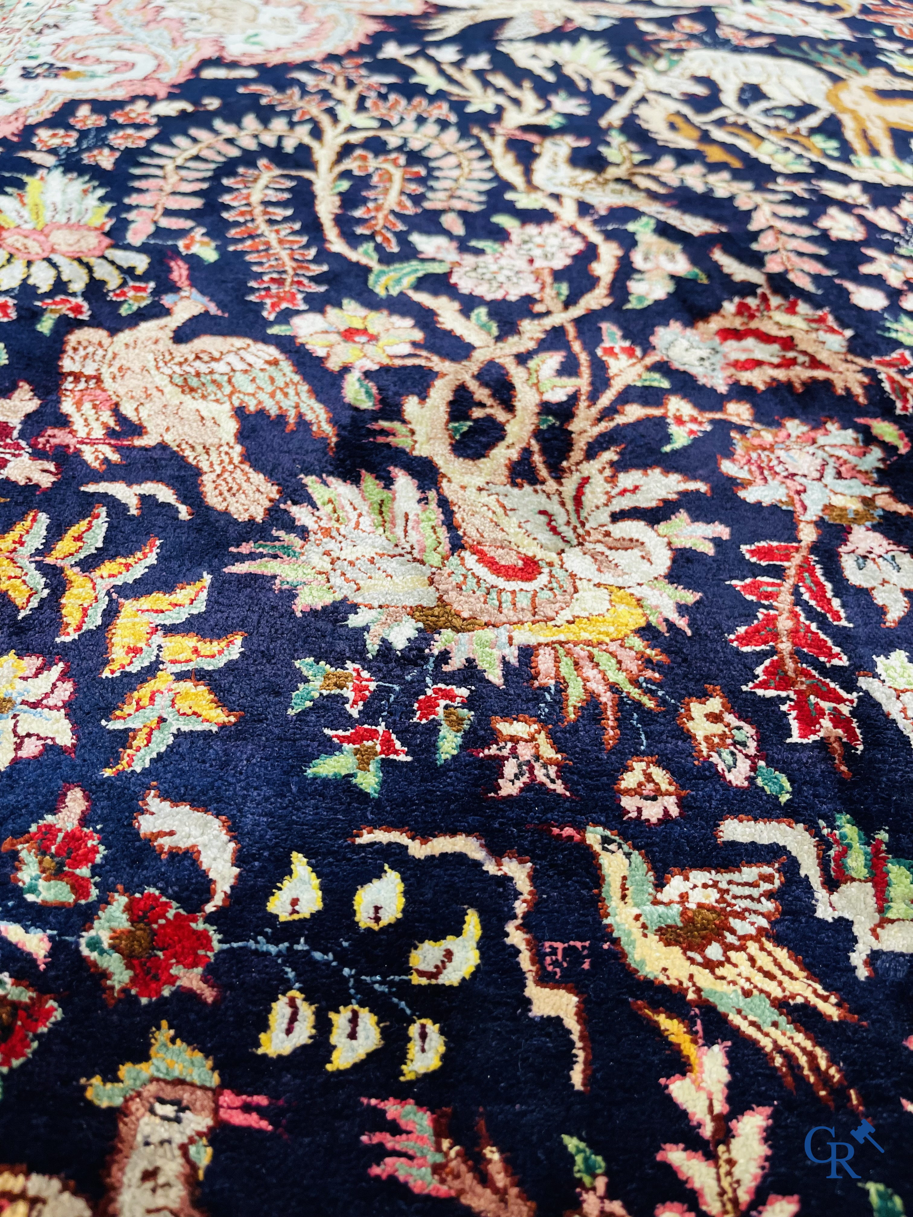 Oriental carpets: Tabriz, a finely hand-knotted silk carpet with forest animals and birds in a floral decor.