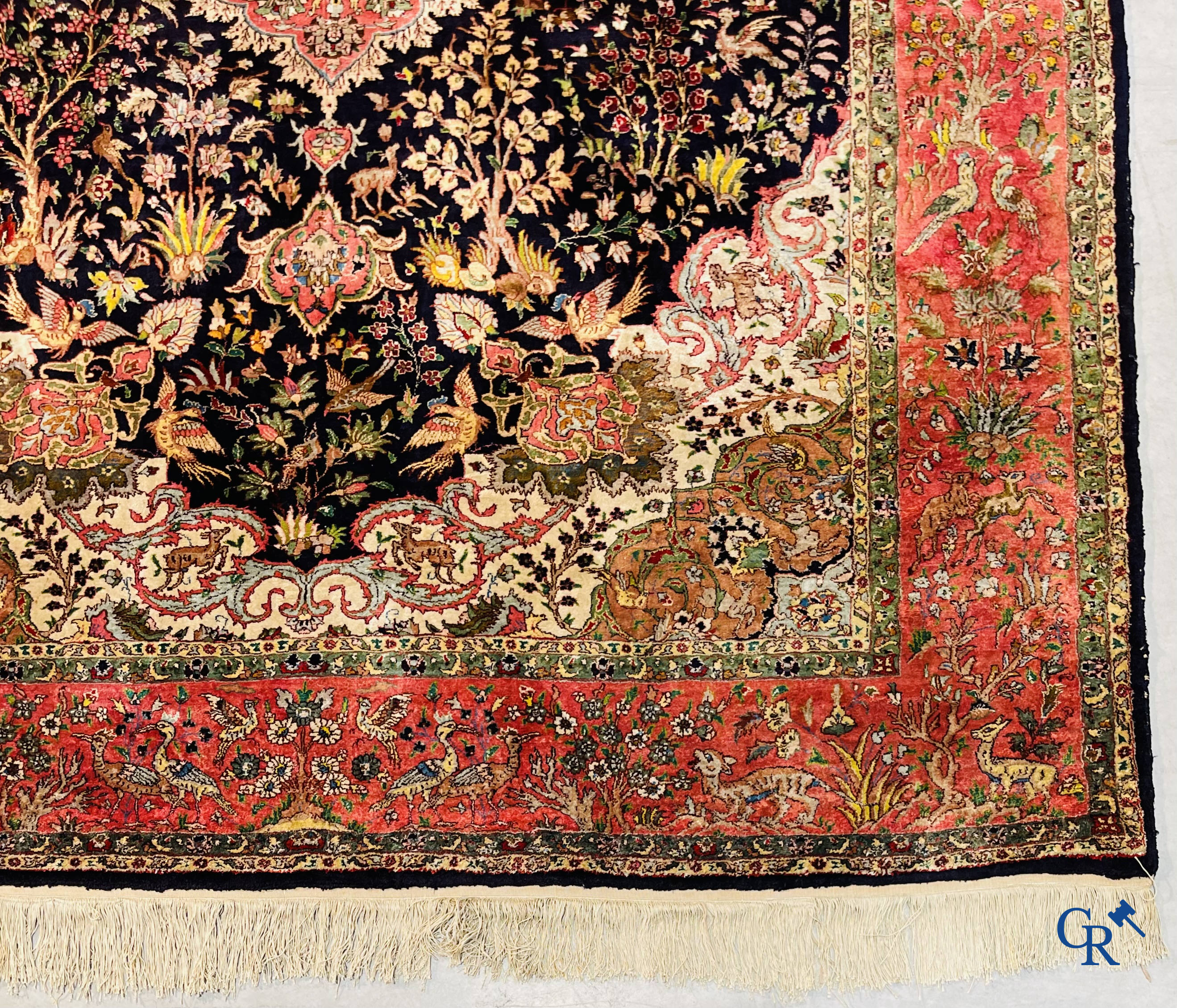 Oriental carpets: Tabriz, a finely hand-knotted silk carpet with forest animals and birds in a floral decor.