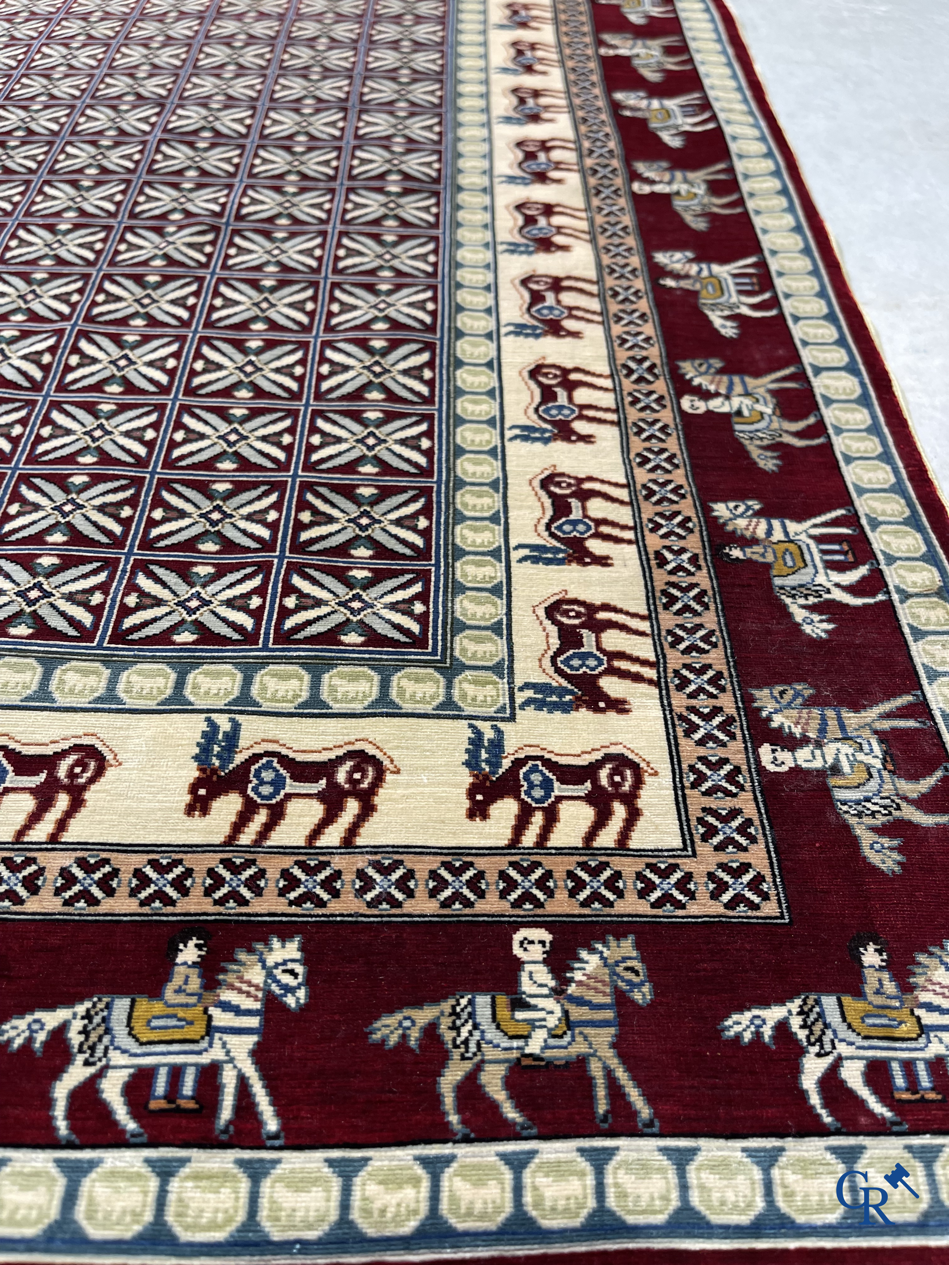 Oriental rugs: A small finely hand-knotted silk rug with deer and horsemen. Signed.