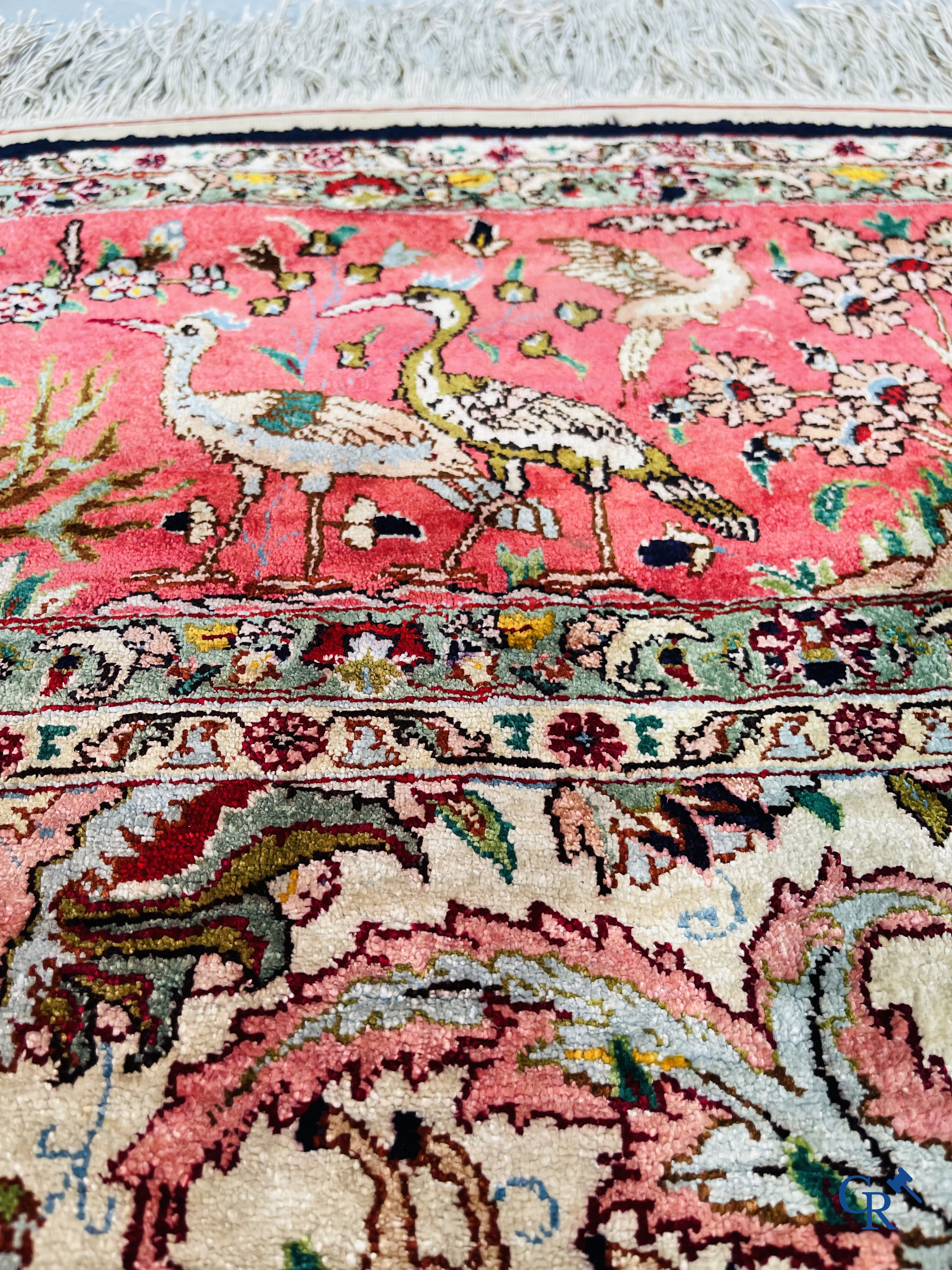 Oriental carpets: Tabriz, a finely hand-knotted silk carpet with forest animals and birds in a floral decor.