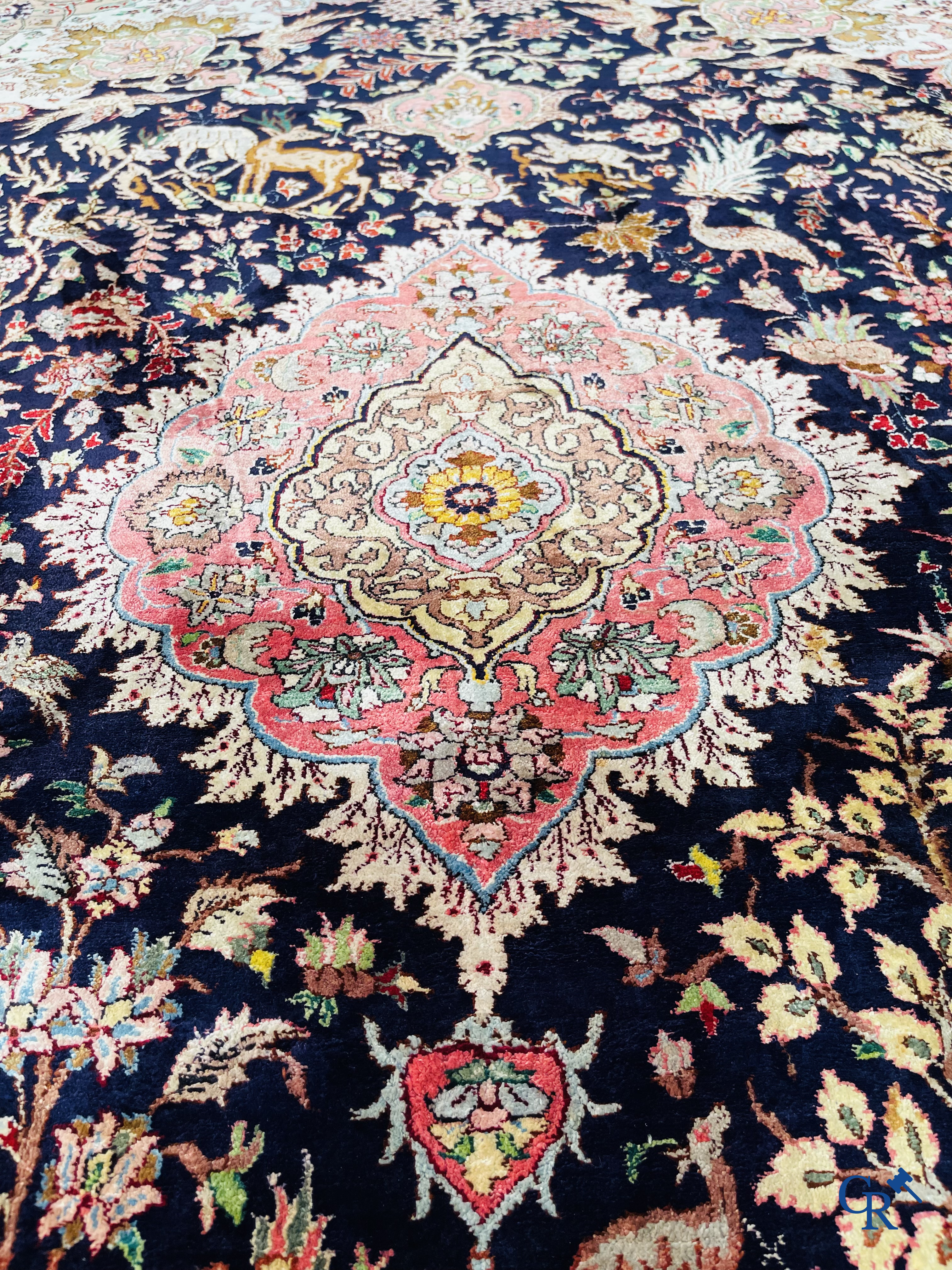 Oriental carpets: Tabriz, a finely hand-knotted silk carpet with forest animals and birds in a floral decor.