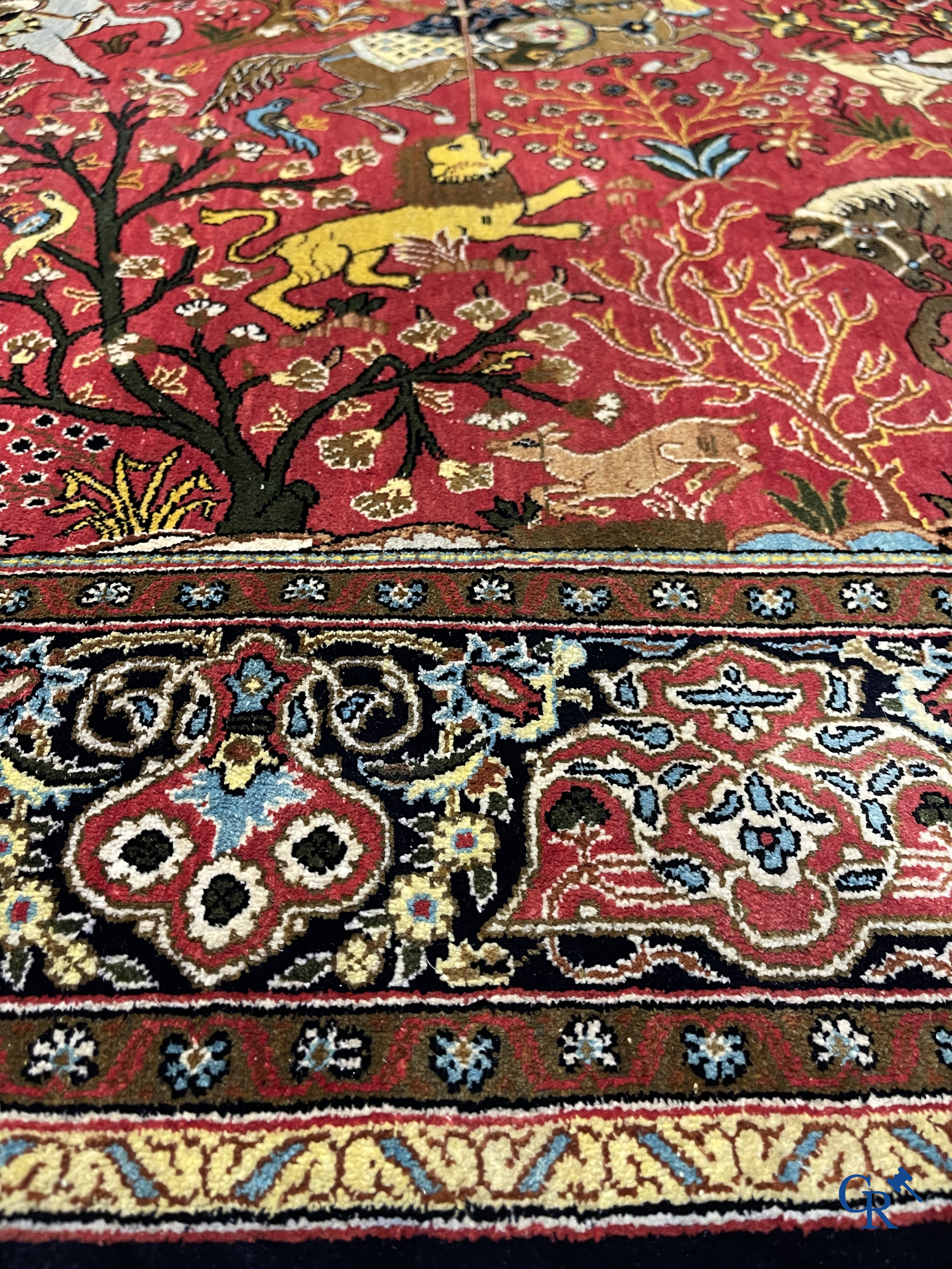 Oriental carpets, a Persian carpet in silk with a scene of hunters on horseback.