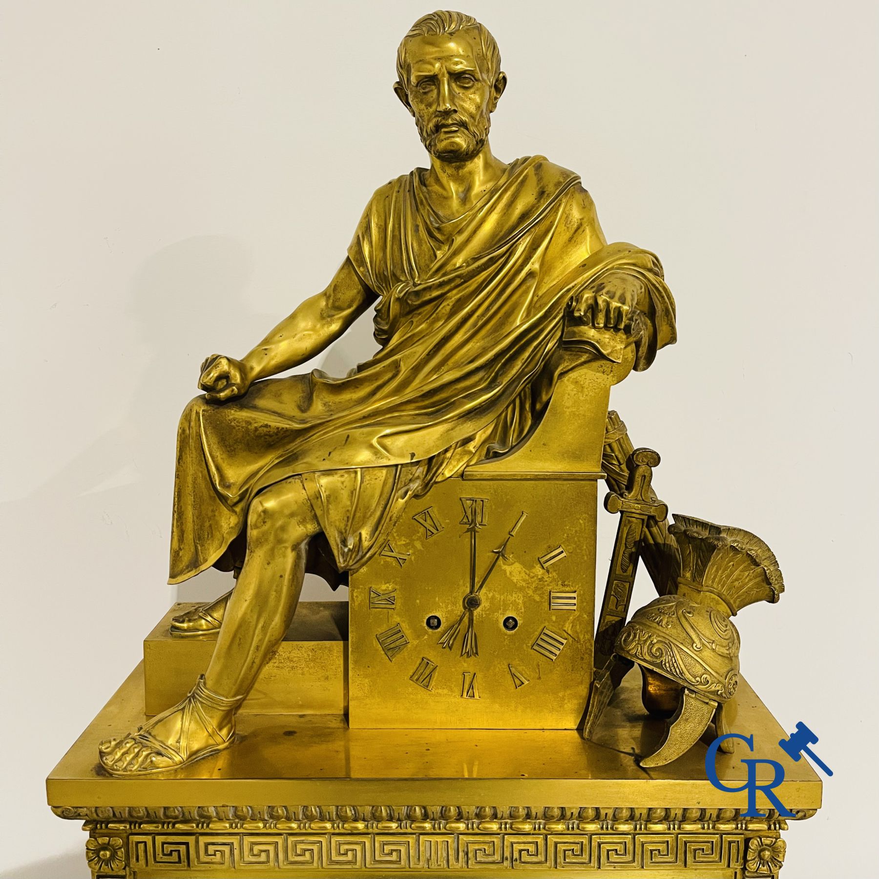 Imposing fire-gilded empire pendulum depicting a seated Roman emperor.