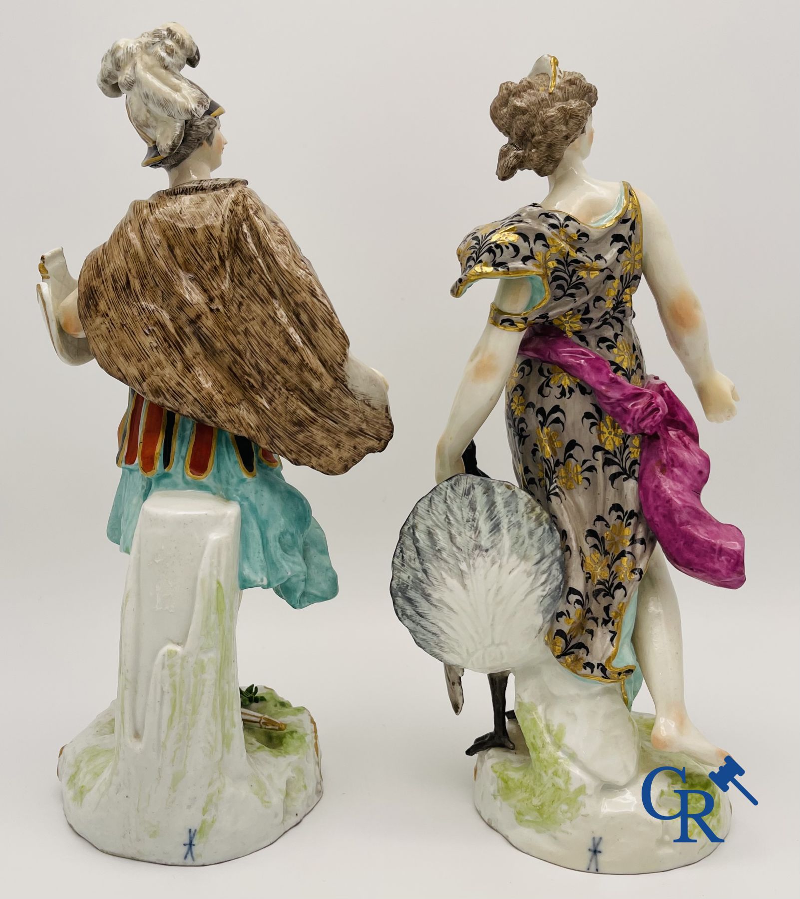 A pair of polychrome porcelain figures in the manner of Meissen.