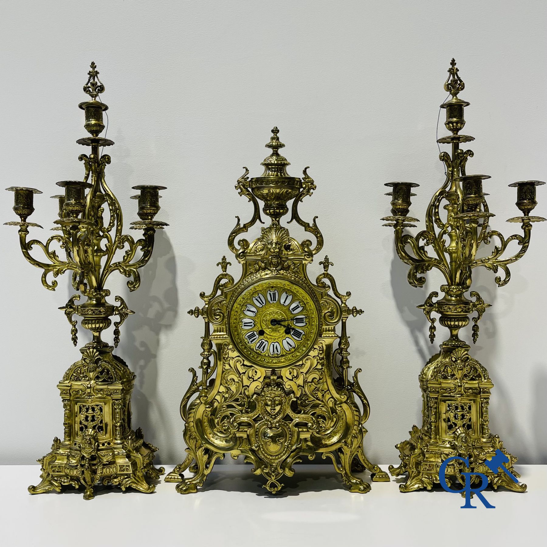 A three-part bronze fireplace clockset in Renaissance style and 2 painted tin and bronze pendant clocks.