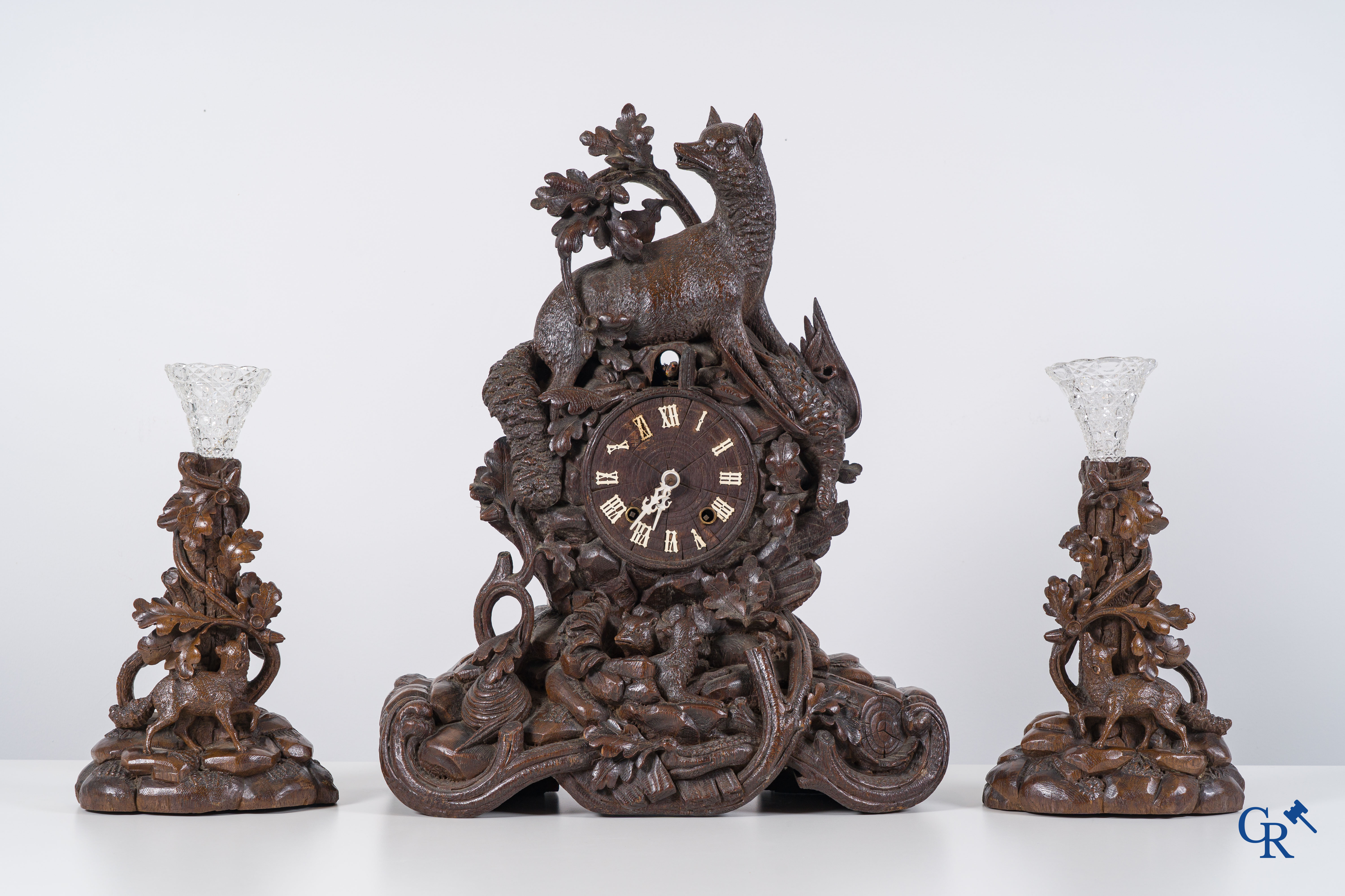 Black Forest, circa 1900. A large 3-piece cuckoo clock in sculpted wood.