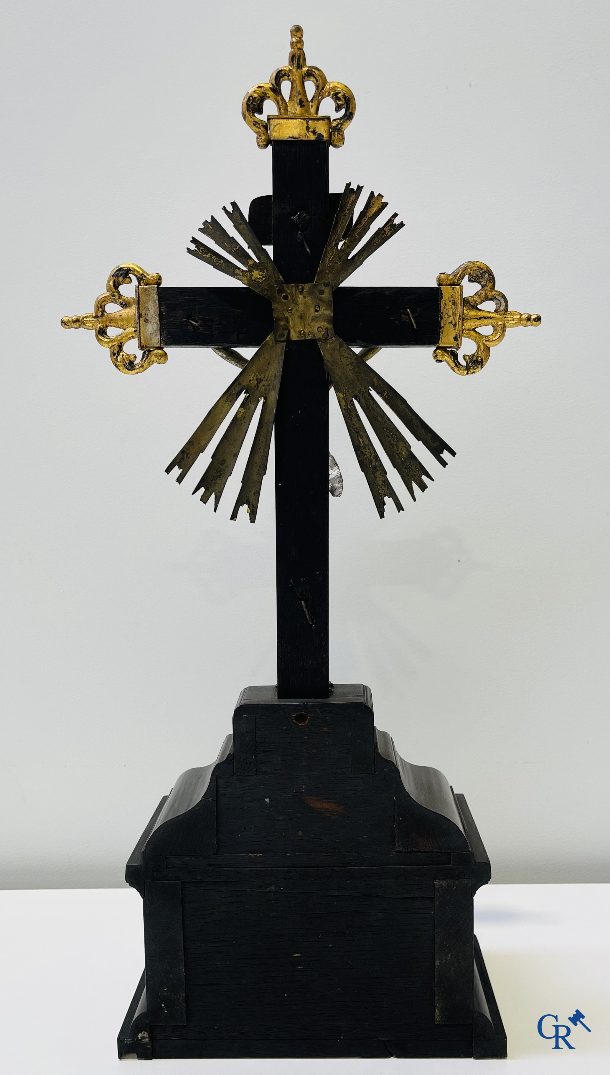 Religious objects: Bronze Christ on the cross held up by an ebony reliquary with relic.