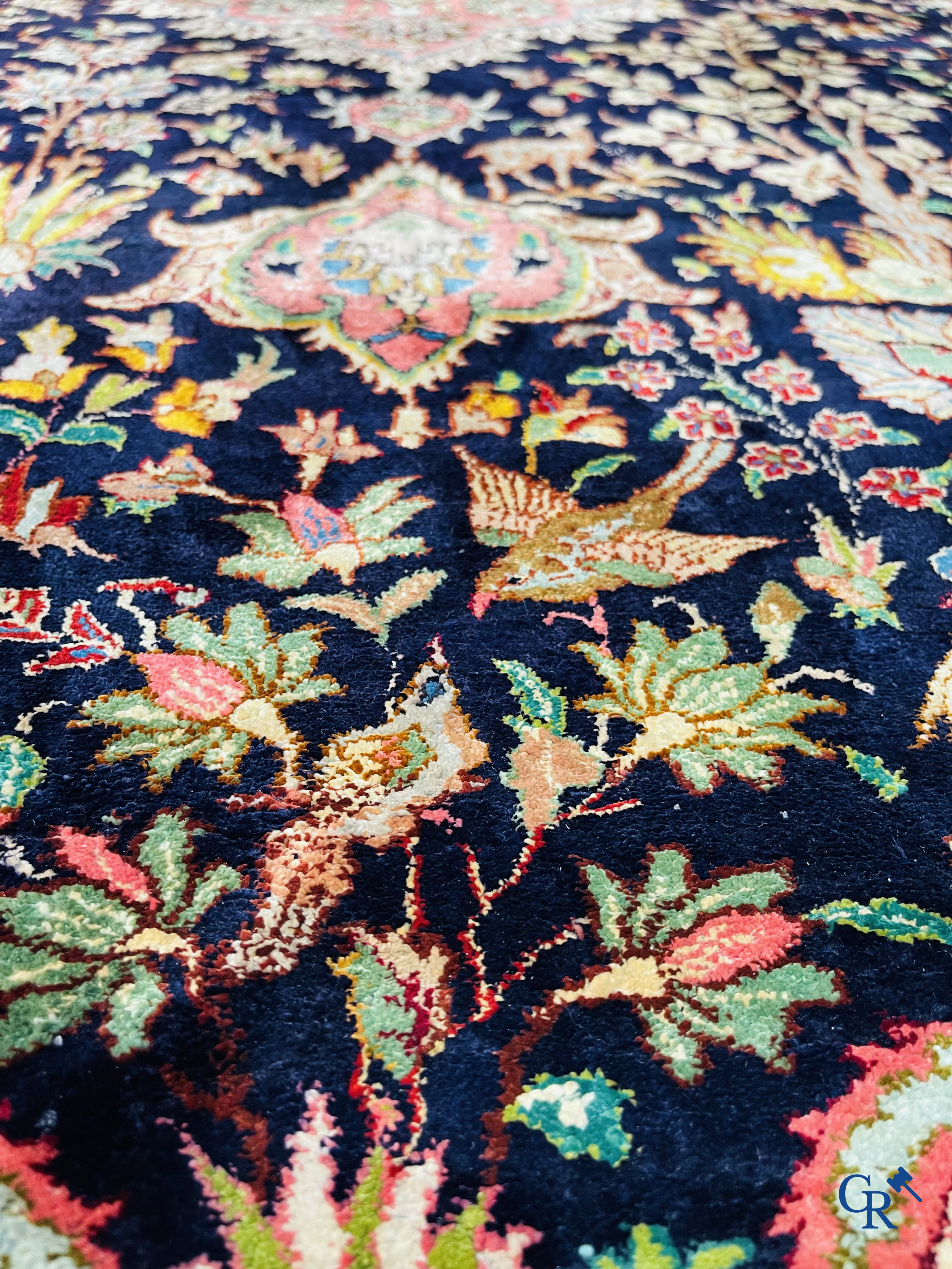 Oriental carpets: Tabriz, a finely hand-knotted silk carpet with forest animals and birds in a floral decor.