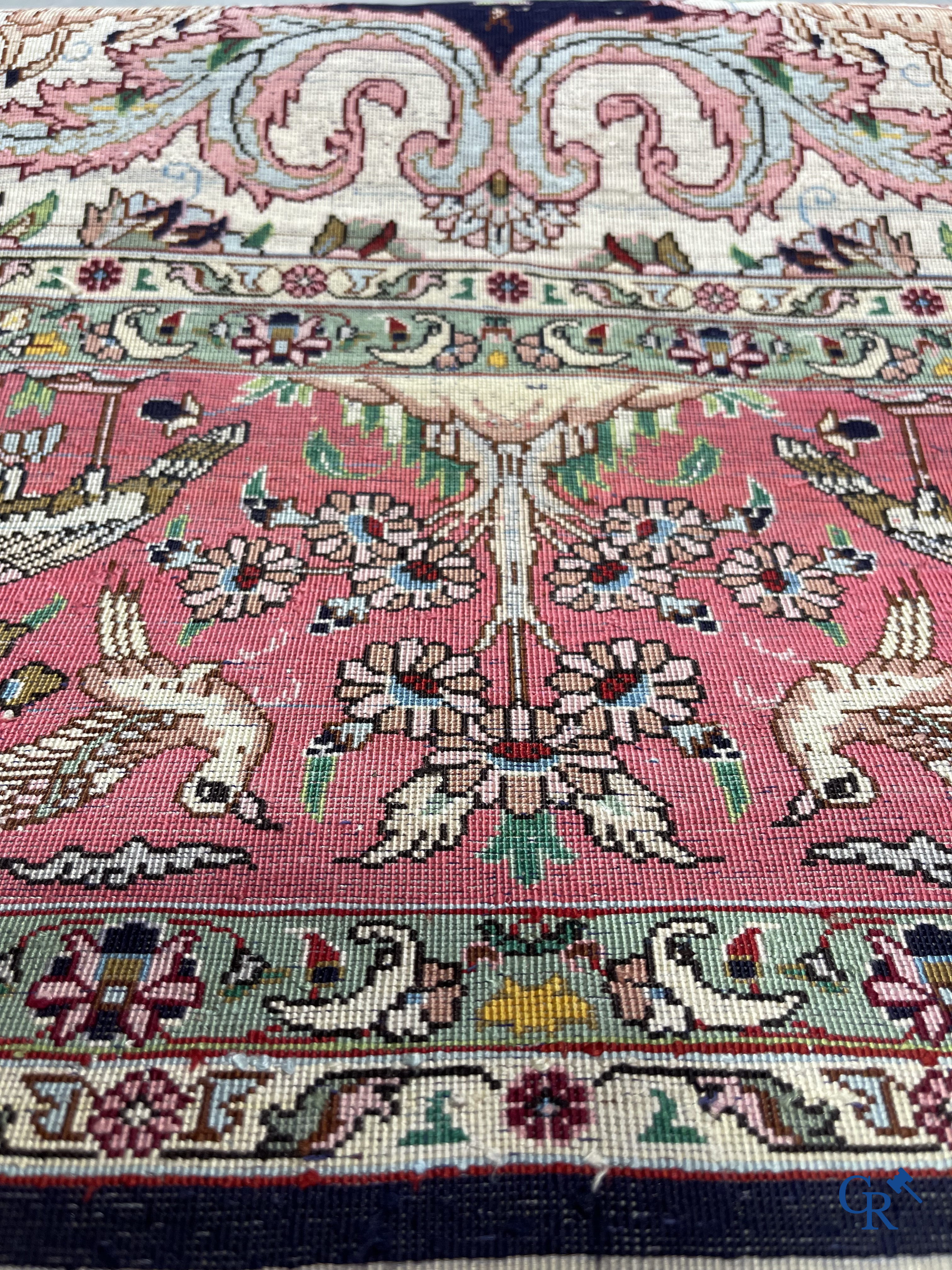 Oriental carpets: Tabriz, a finely hand-knotted silk carpet with forest animals and birds in a floral decor.