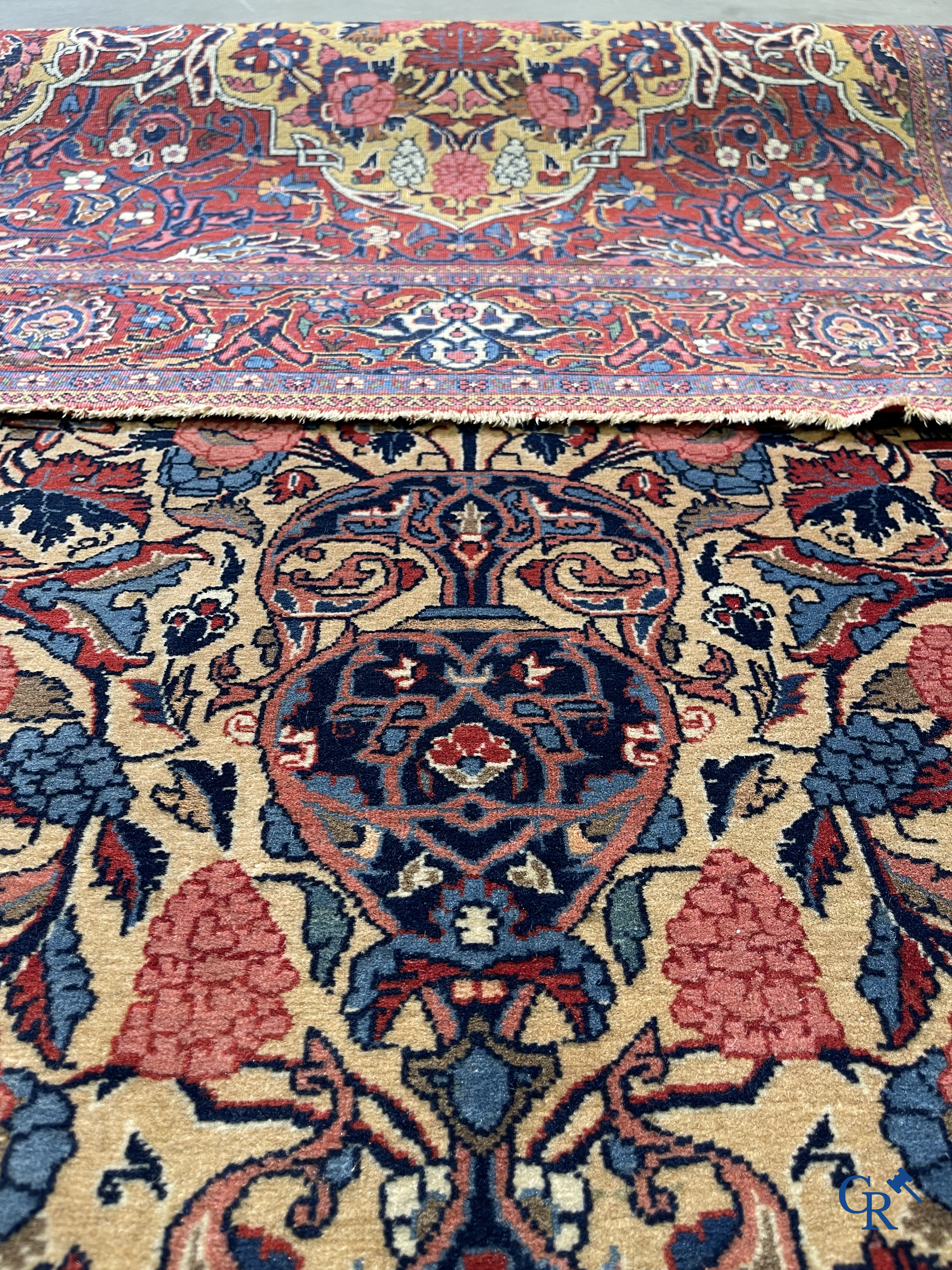 Oriental carpets: Iran. 2 antique hand-knotted Persian carpets with floral decor.