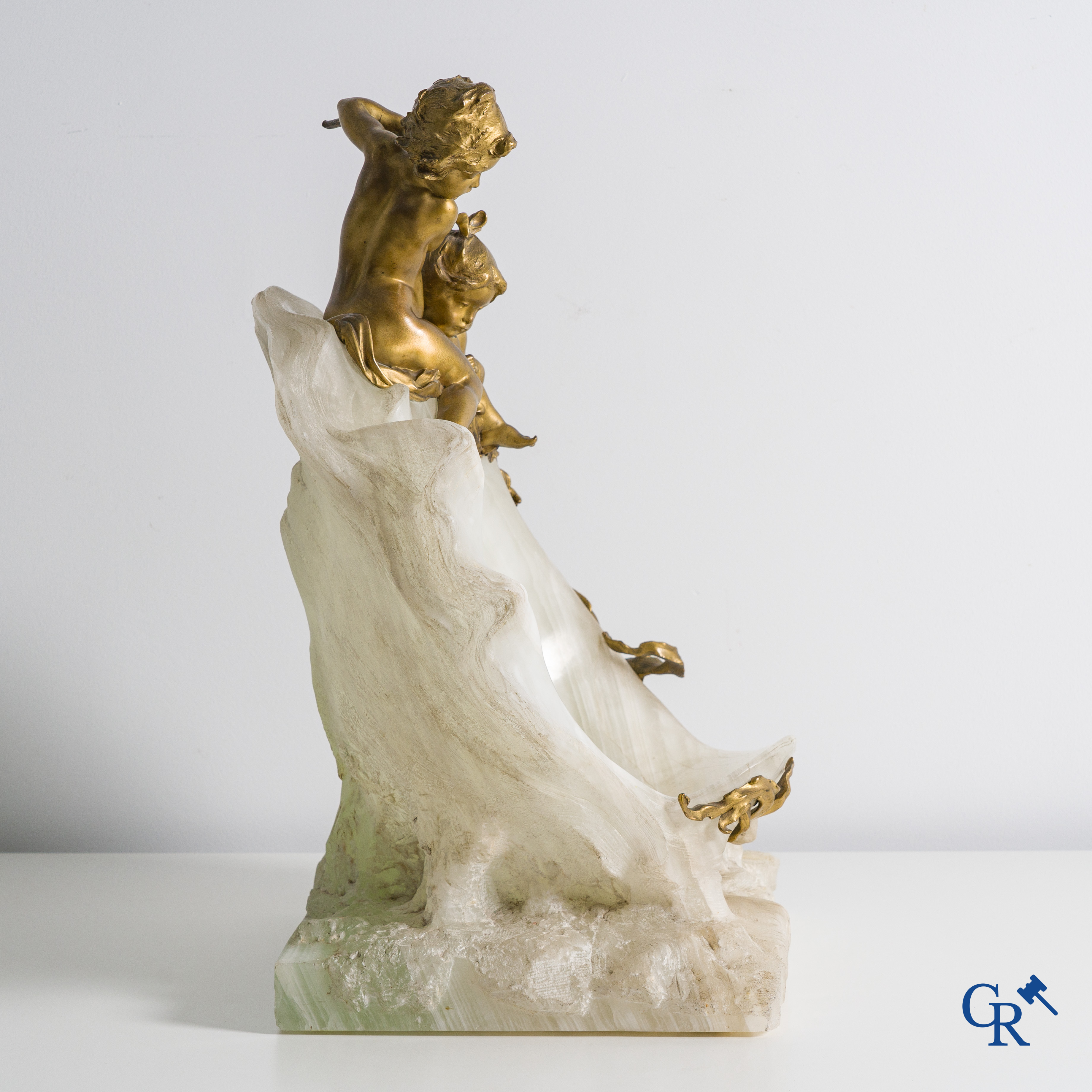 Henri Pernot (1859 - 1937) Spelende putti op een grote open zeeschelp. Witte onyx en vergulde brons. Circa 1900.