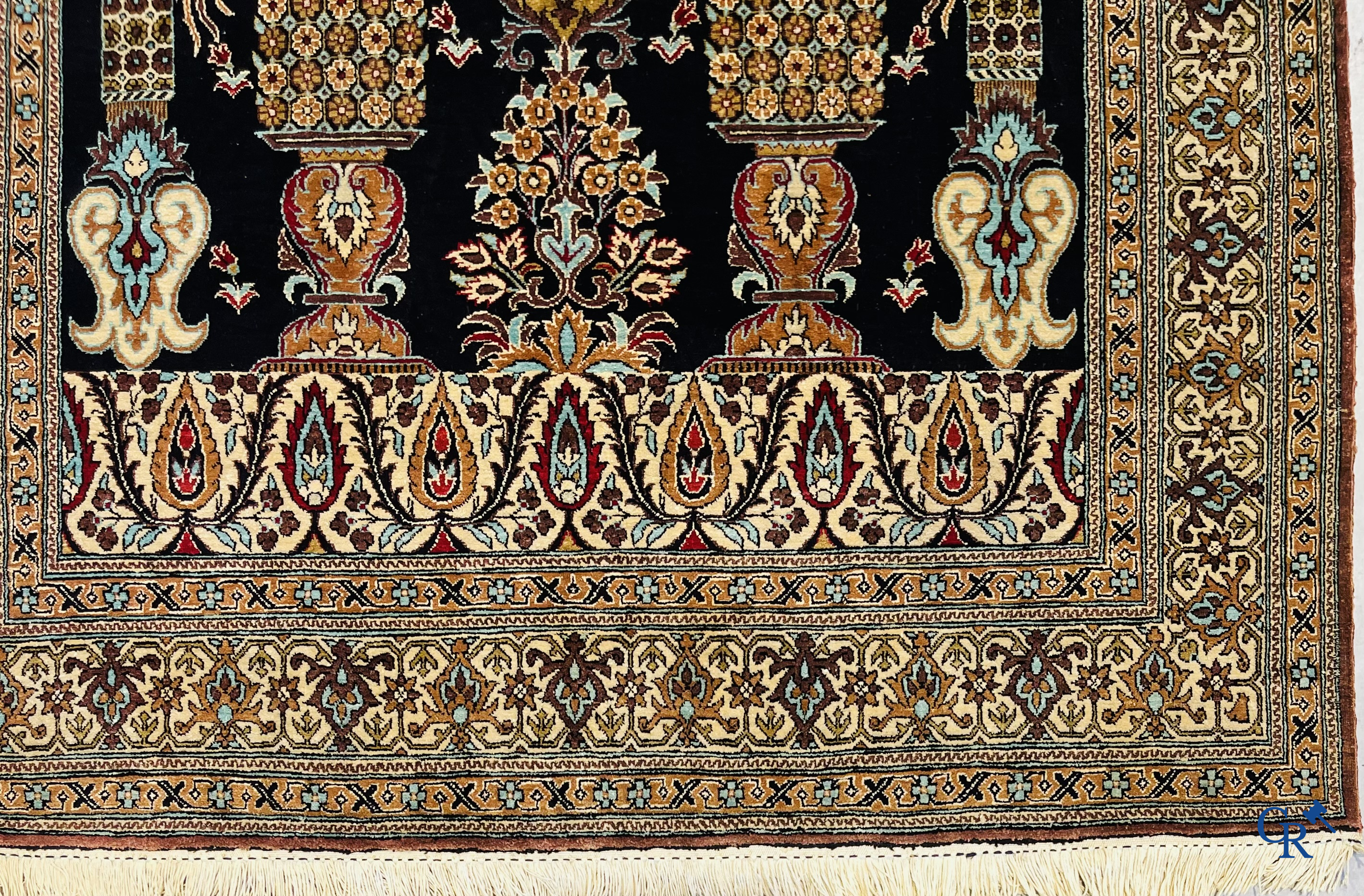 Persian carpets: A finely knotted silk Ghoum carpet with a decor of birds and flowers.