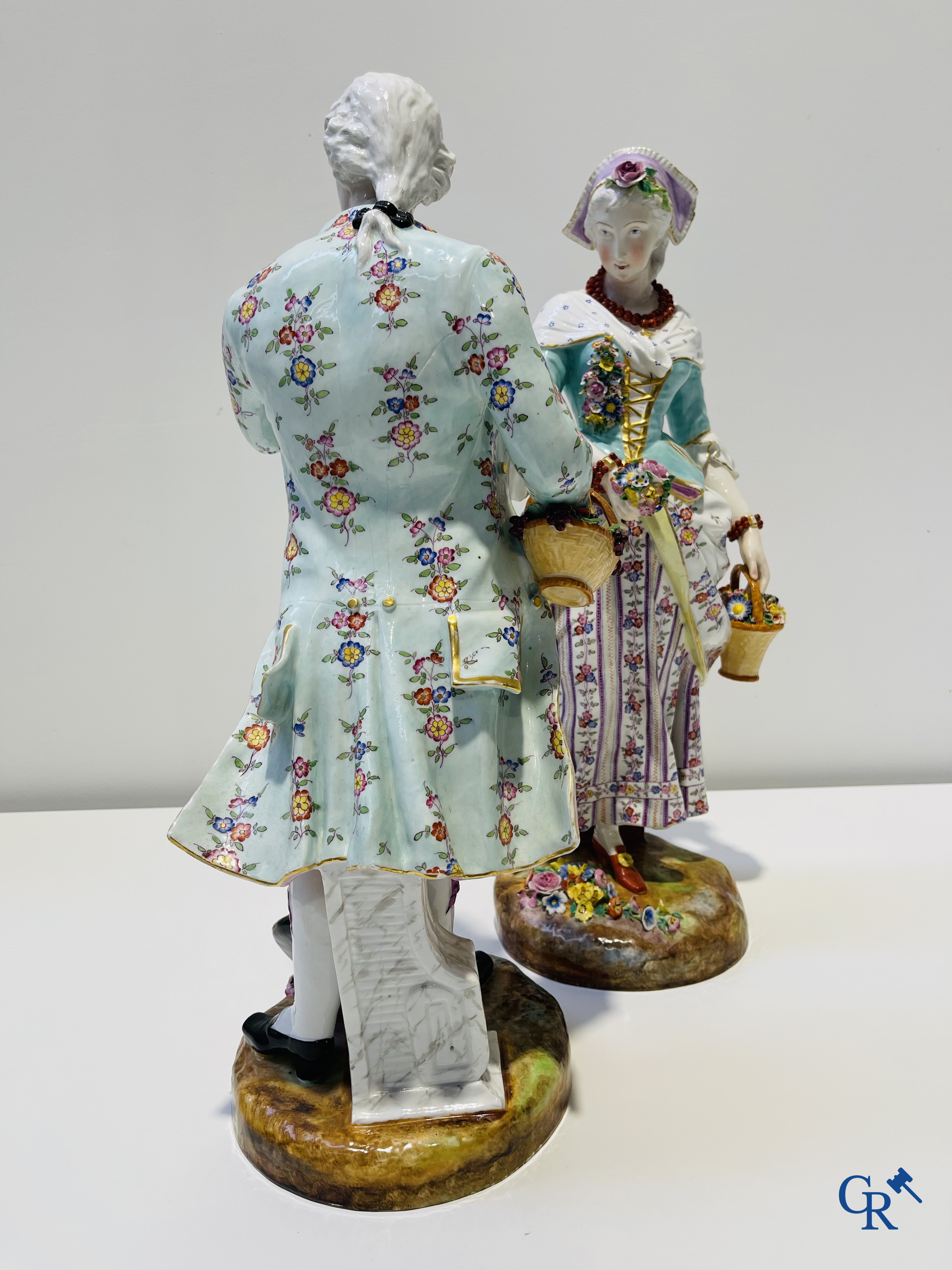 Exceptionally large pair of romantic statues in coloured and gilded porcelain in the manner of Meissen.