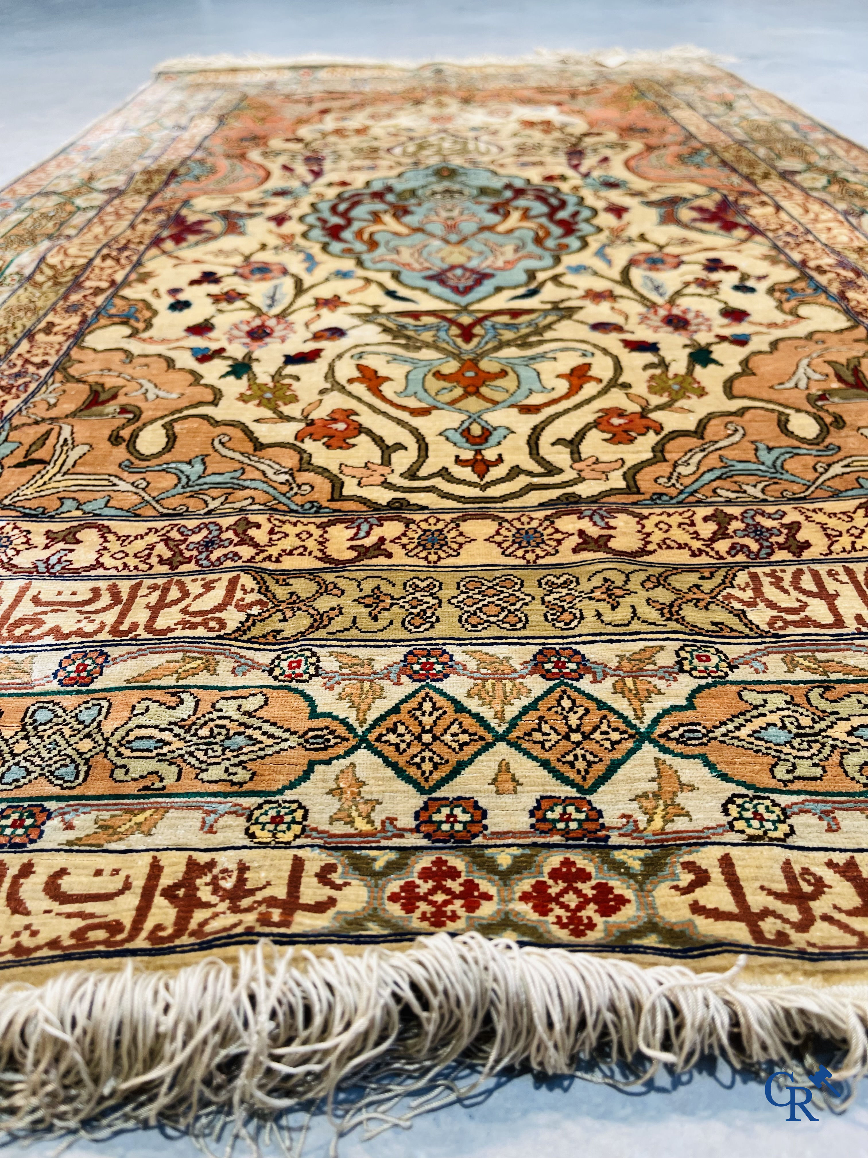 Oriental carpets, Hereke Turkey, a finely hand-knotted silk carpet with inscriptions and gold thread.