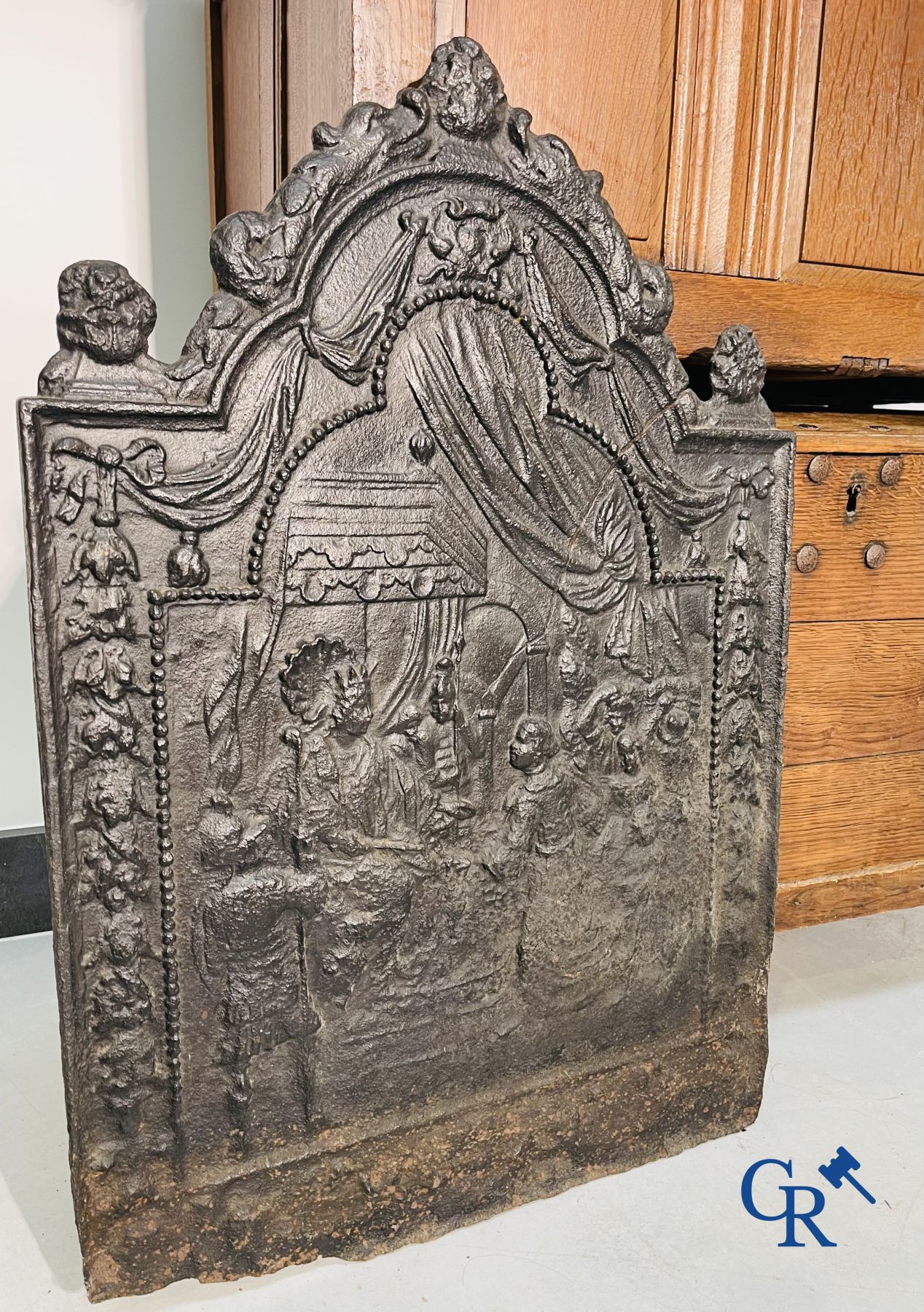 2 oak chests and an antique cast iron fireplace plate.