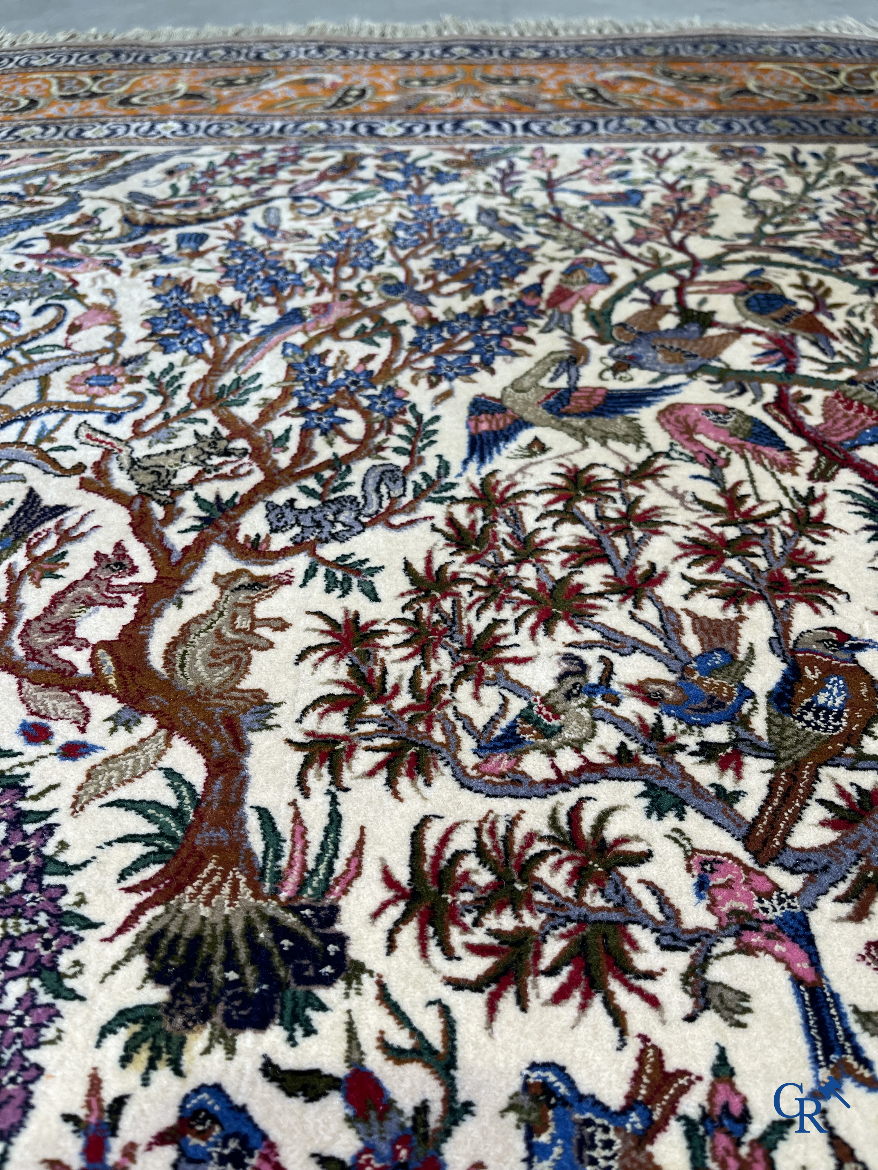 Oriental carpets, a finely hand-knotted silk carpet with forest animals. Signed.