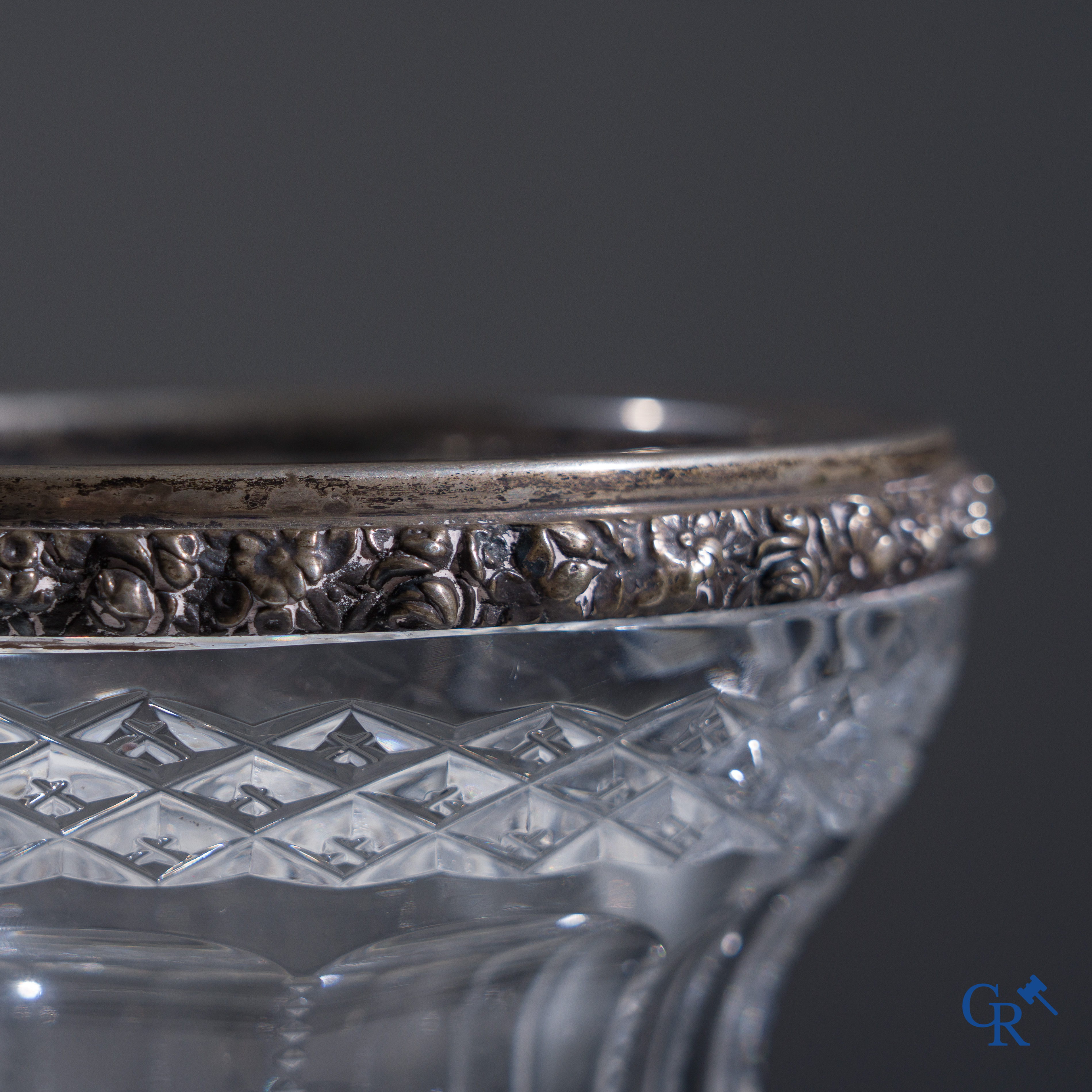 An imposing crystal vase with a silver frame.