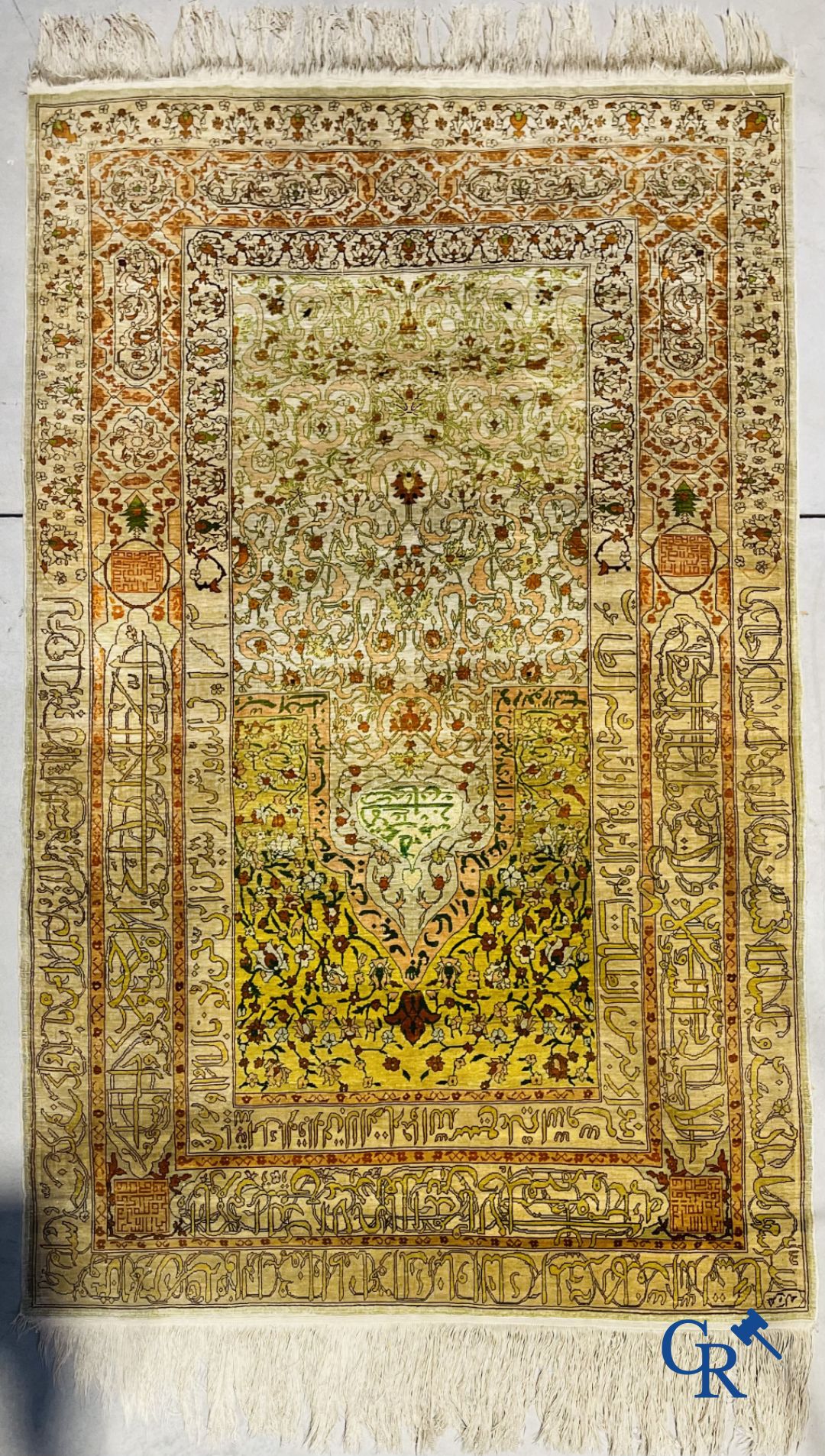 Oriental carpets: An exceptionally signed carpet in silk and gold thread with verses and a floral decor.