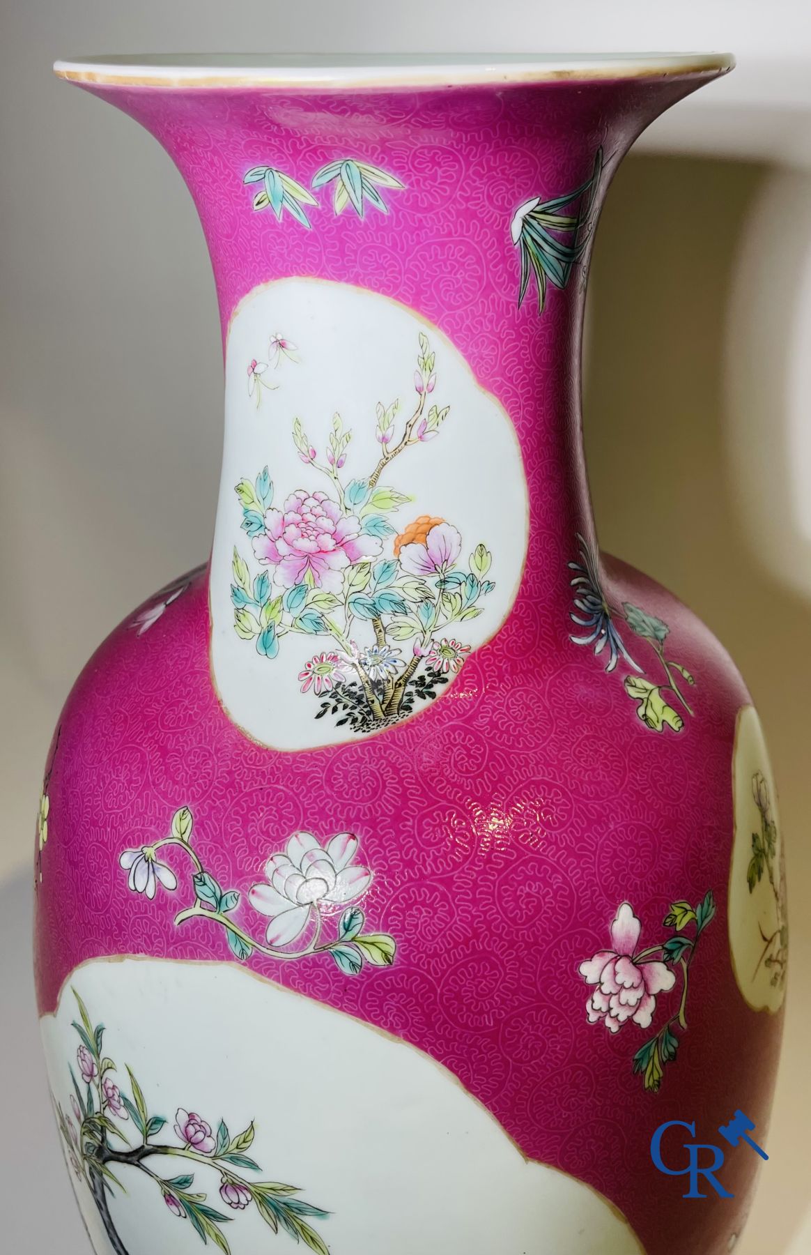 Chinese porcelain: A fine famille rose vase decorated on a red ruby background in sgraffito technique.