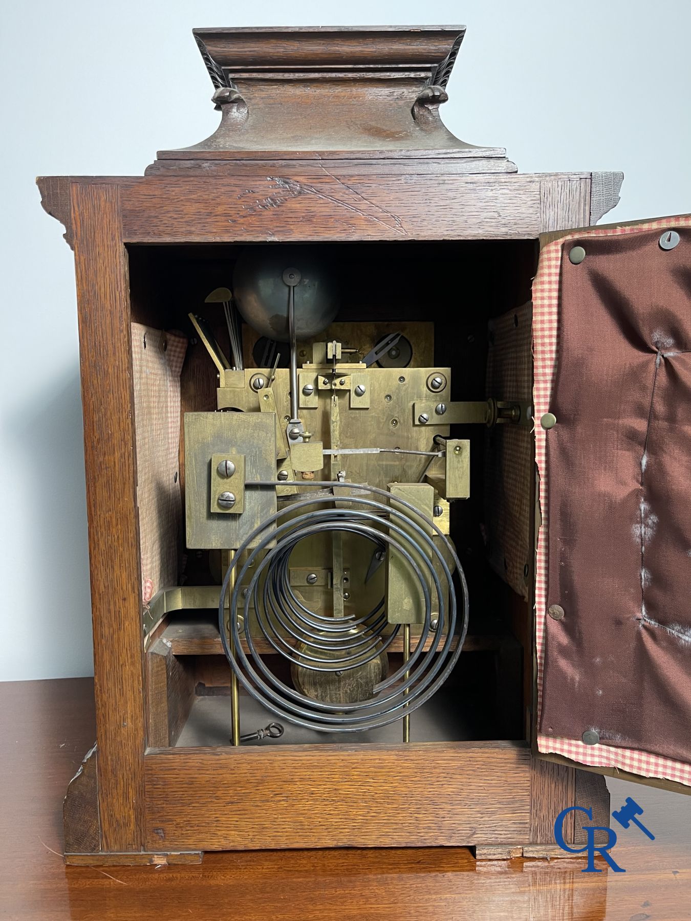 Clock with multiple bells and music in oak sculpted case with matching pedestal.