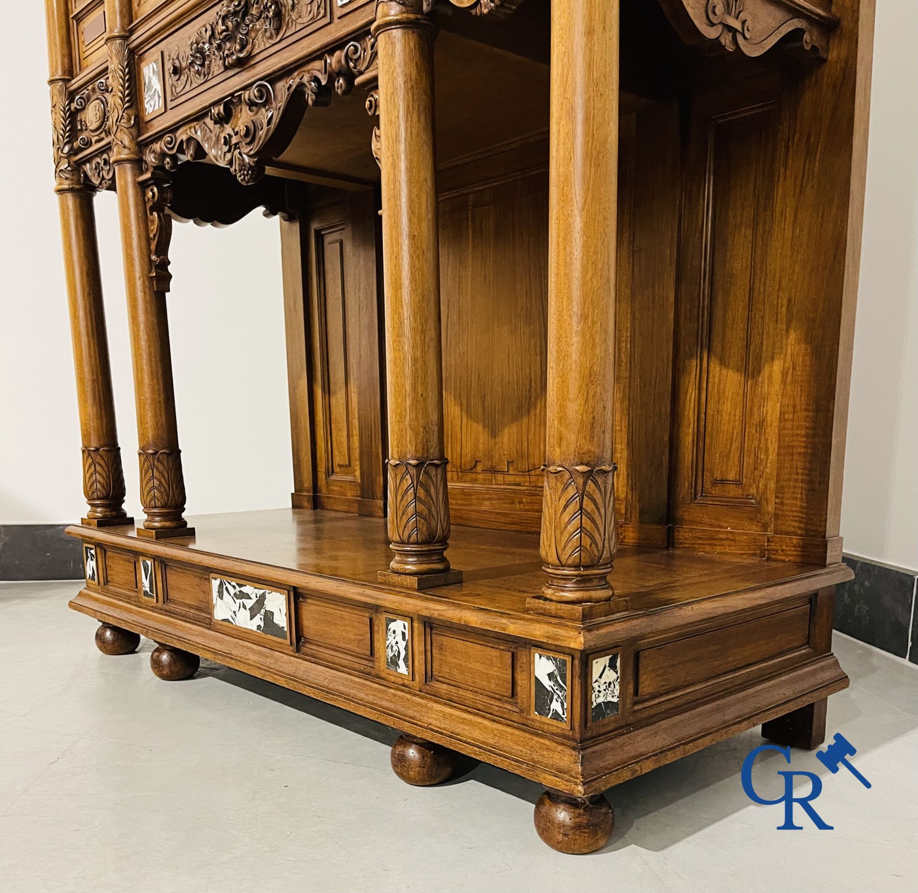 Furniture: A finely carved walnut credence in neo renaissance style with marble inlay.