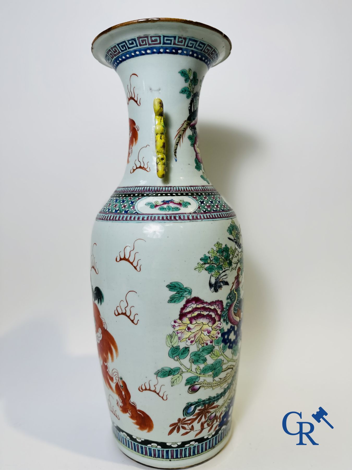 Chinese porcelain: A Chinese famille rose vase with a decor of Buddhist lions, phoenixes, birds and peonies.