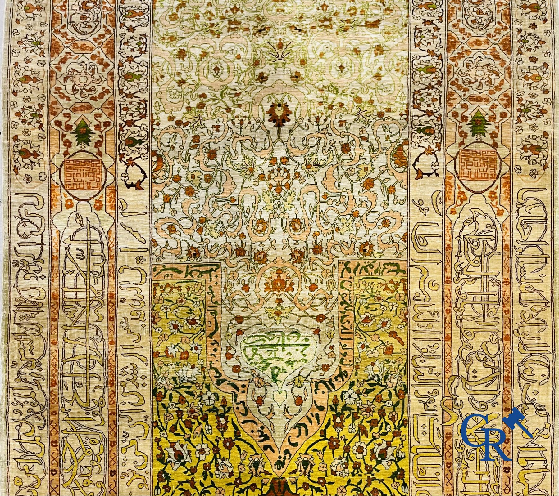 Oriental carpets: An exceptionally signed carpet in silk and gold thread with verses and a floral decor.