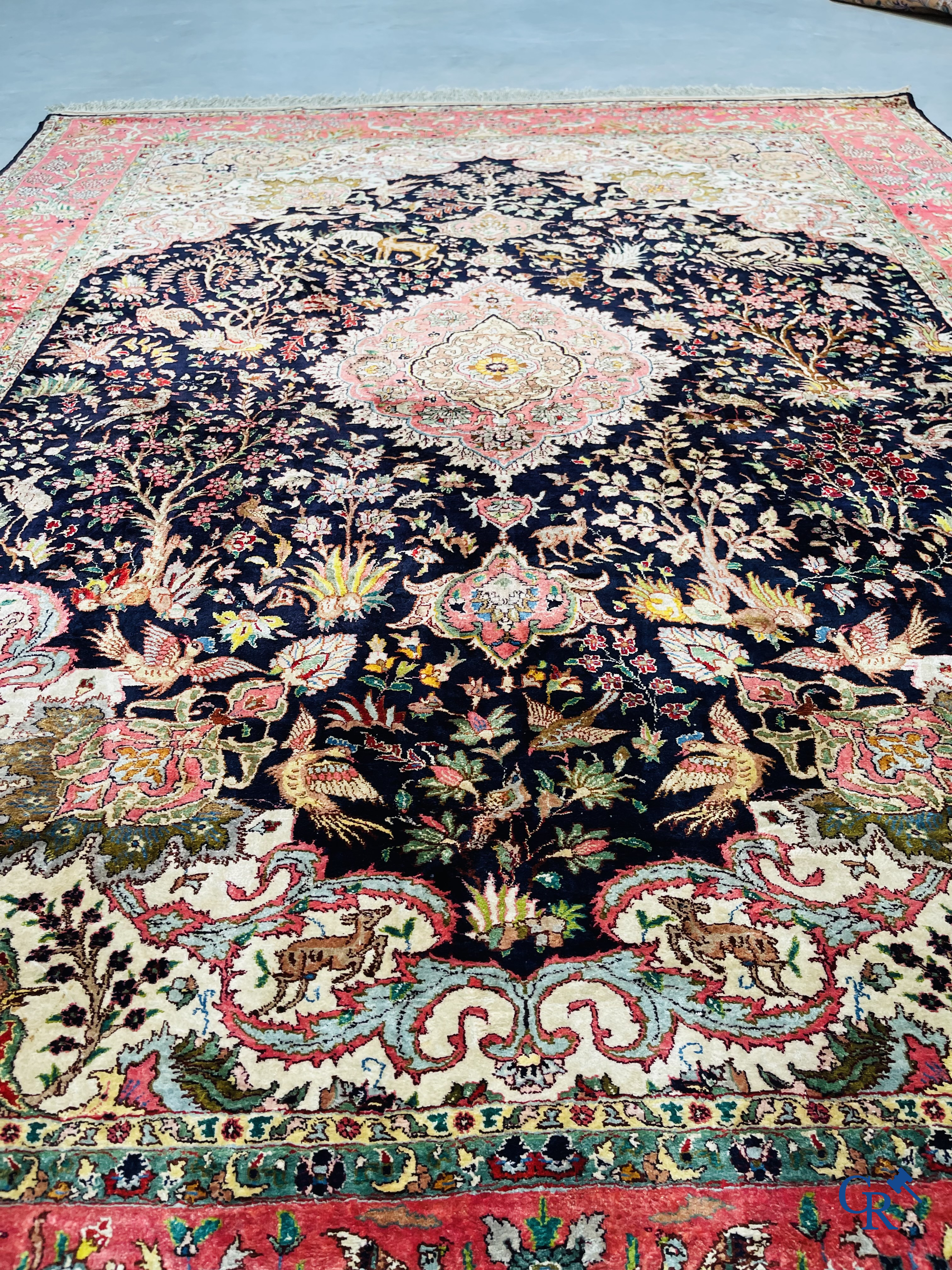 Oriental carpets: Tabriz, a finely hand-knotted silk carpet with forest animals and birds in a floral decor.